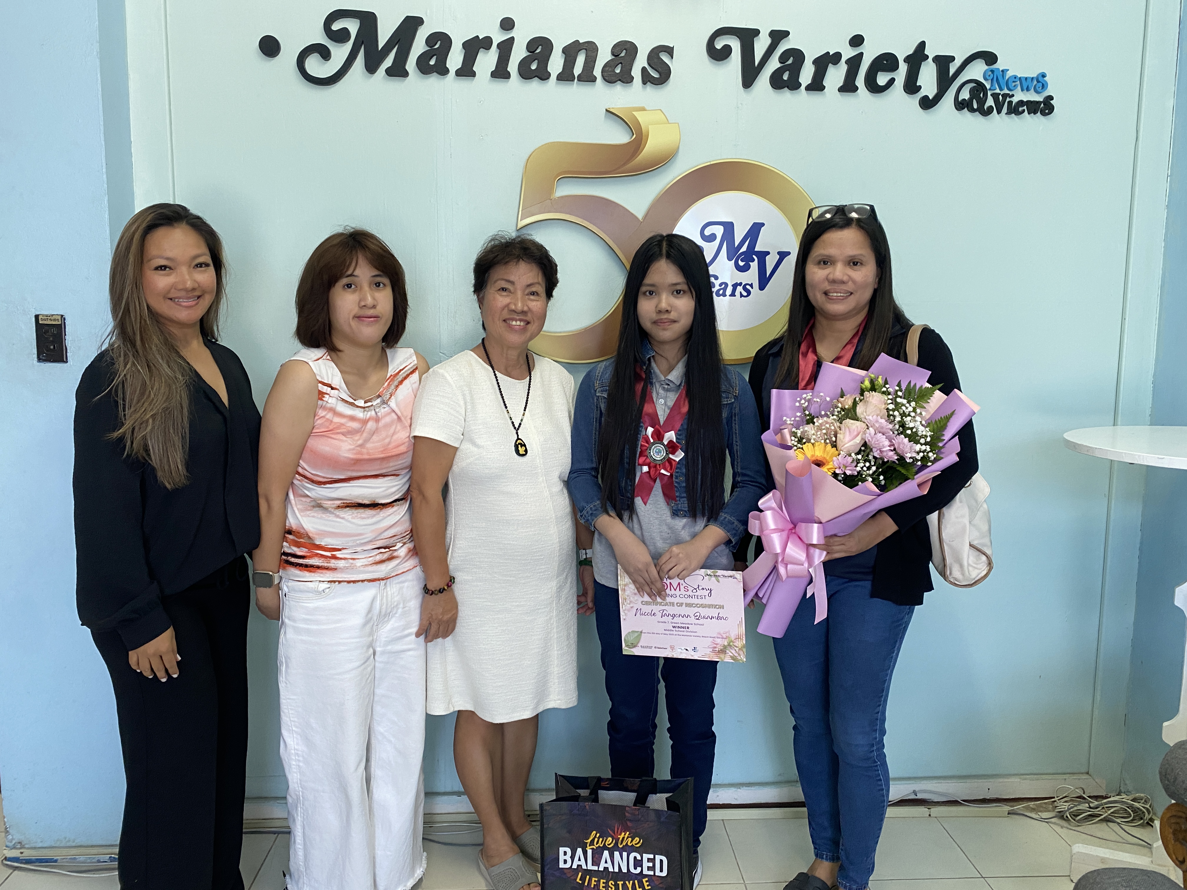 Seventh grader Nicole Tangonan, second from right, and her mother, far right. 