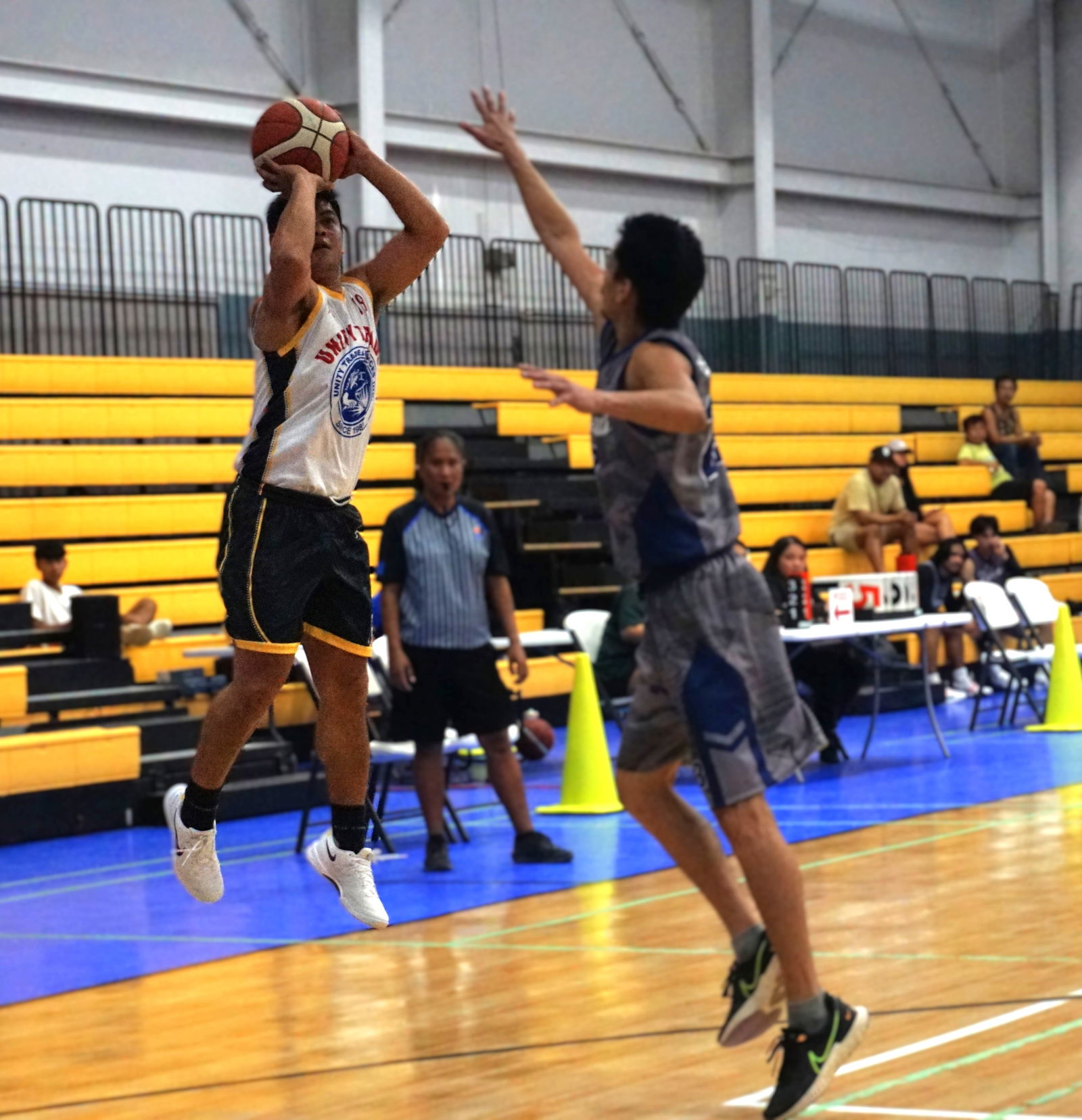 Unity Trade's Rodel Pastrana takes the contested three-point shot during the Michelob Ultra Cup championship game against Marianas at the Ada gym on Wednesday.Photo by James F. Sablan Jr.