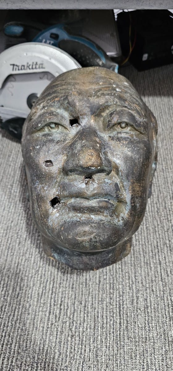 A portion of the damaged bust of war veteran Yong Taek Lee was found at a recycling center in Lower Base.Contributed photo