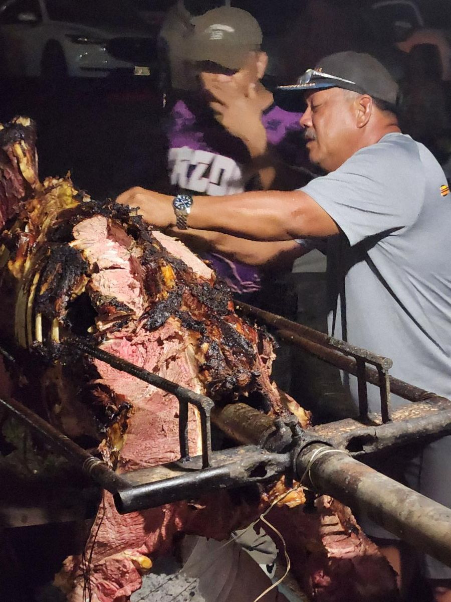 Tinian Mayor Edwin Aldan serves fresh roasted cow to patrons at the 26th Annual Taste of the Marianas International Food Festival on May 17, 2025, at American Memorial Park, Saipan.