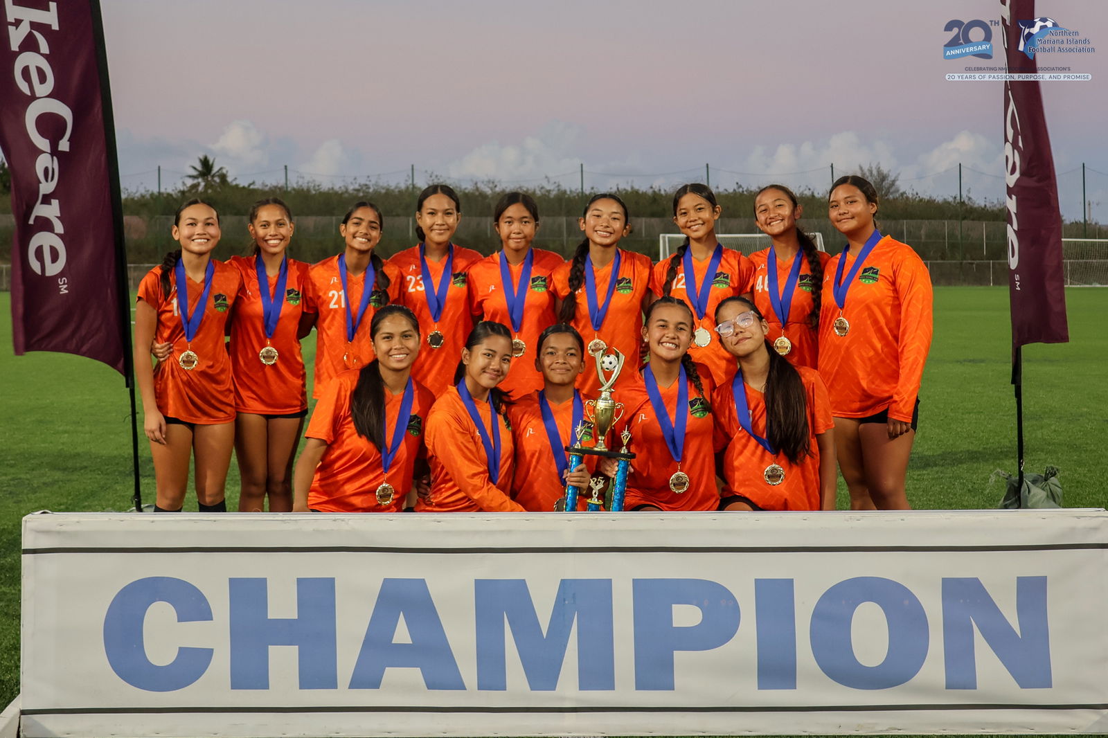 Kanoa Football Club players pose with the U17 girls division championship trophy during the awards ceremony of the TakeCare Youth Soccer League Spring 2025 on Saturday at the NMI Soccer Training Center in Koblerville.NMIFA photo