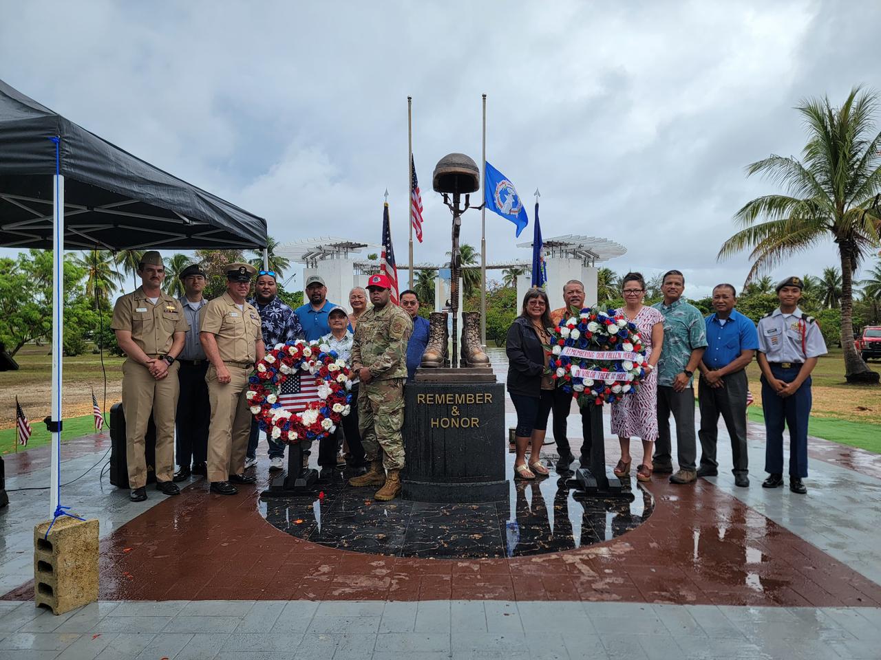 U.S. Congresswoman Kimberlyn King-Hinds, fourth right, and Tinian Mayor Edwin P. Aldan hold the wreath as they, along with other Tinian leaders, join U.S. servicemembers in honoring the nation’s fallen heroes on Memorial Day, Monday, on Tinian.Contributed photo