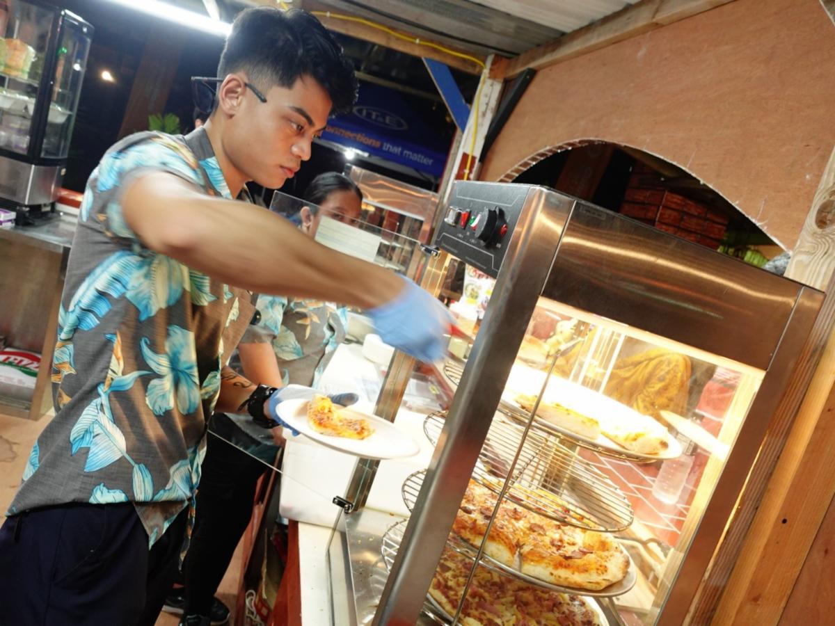 Crowne Plaza Resort Saipan serves hot pizza at the 26th Annual Taste of the Marianas International Food Festival on May 3, 2025, in Saipan. The annual signature event of the Marianas Visitors Authority featuring food, drinks, arts & crafts, and live entertainment will be held every Saturday evening in May at American Memorial Park, Garapan.