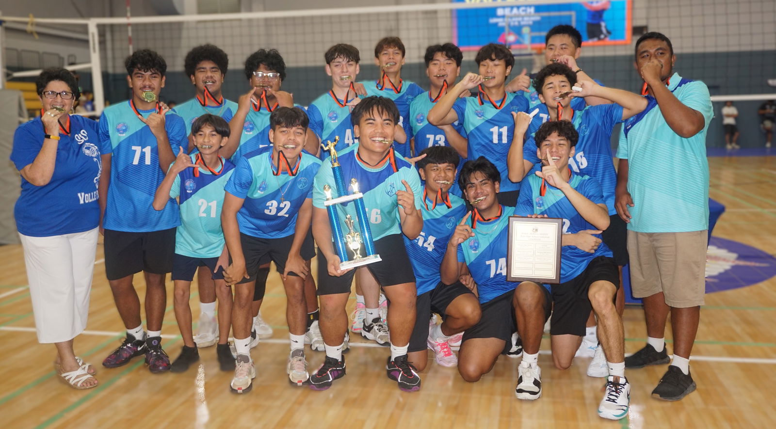 Saipan International School players pose with the boys high school division championship trophy of the PSS-NMIVA Interscholastic Volleyball League SY24-25 at the Ada gym on Saturday.Photo by James F. Sablan Jr.