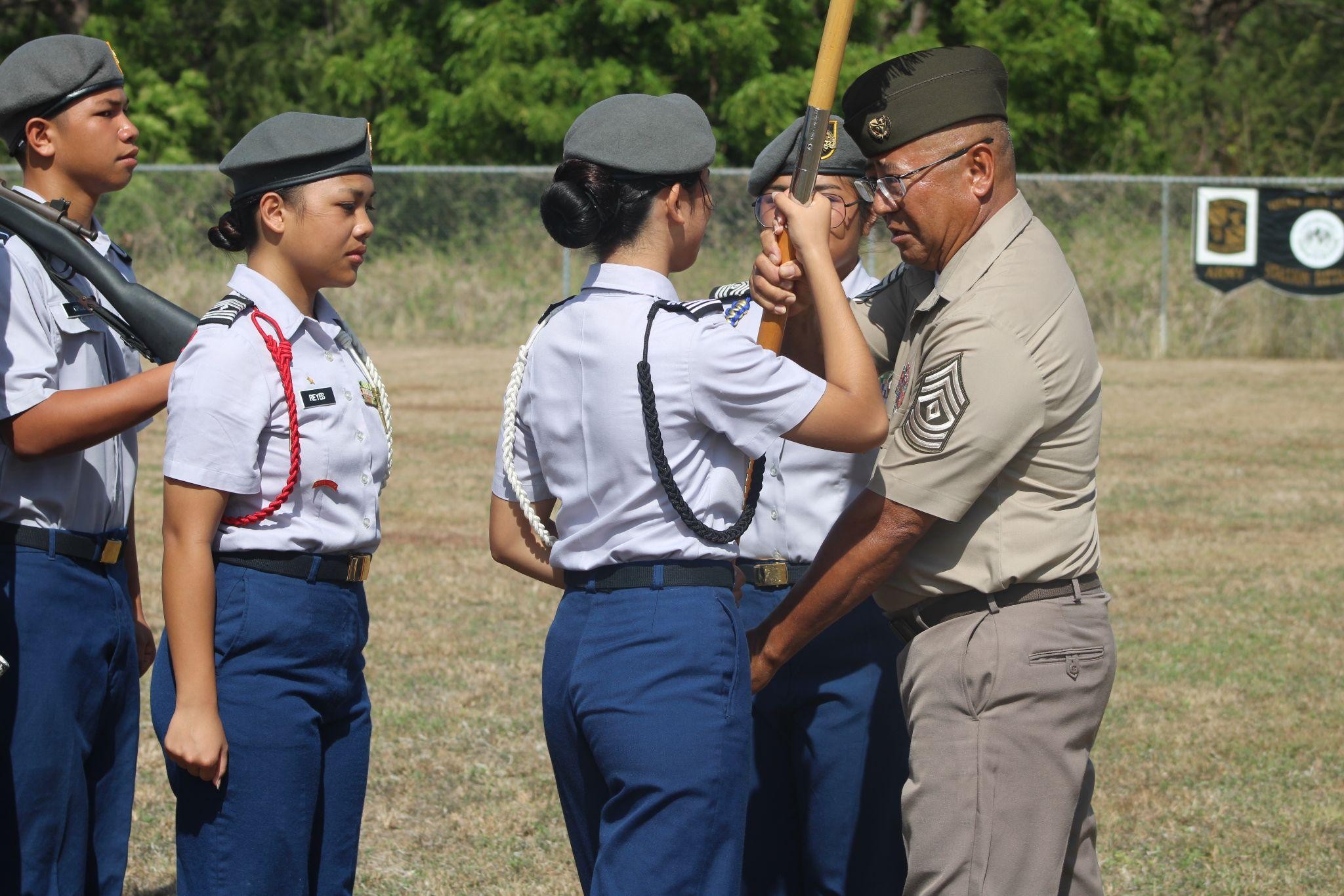 The outgoing command sergeant major relinquishes responsibilities to her successor.