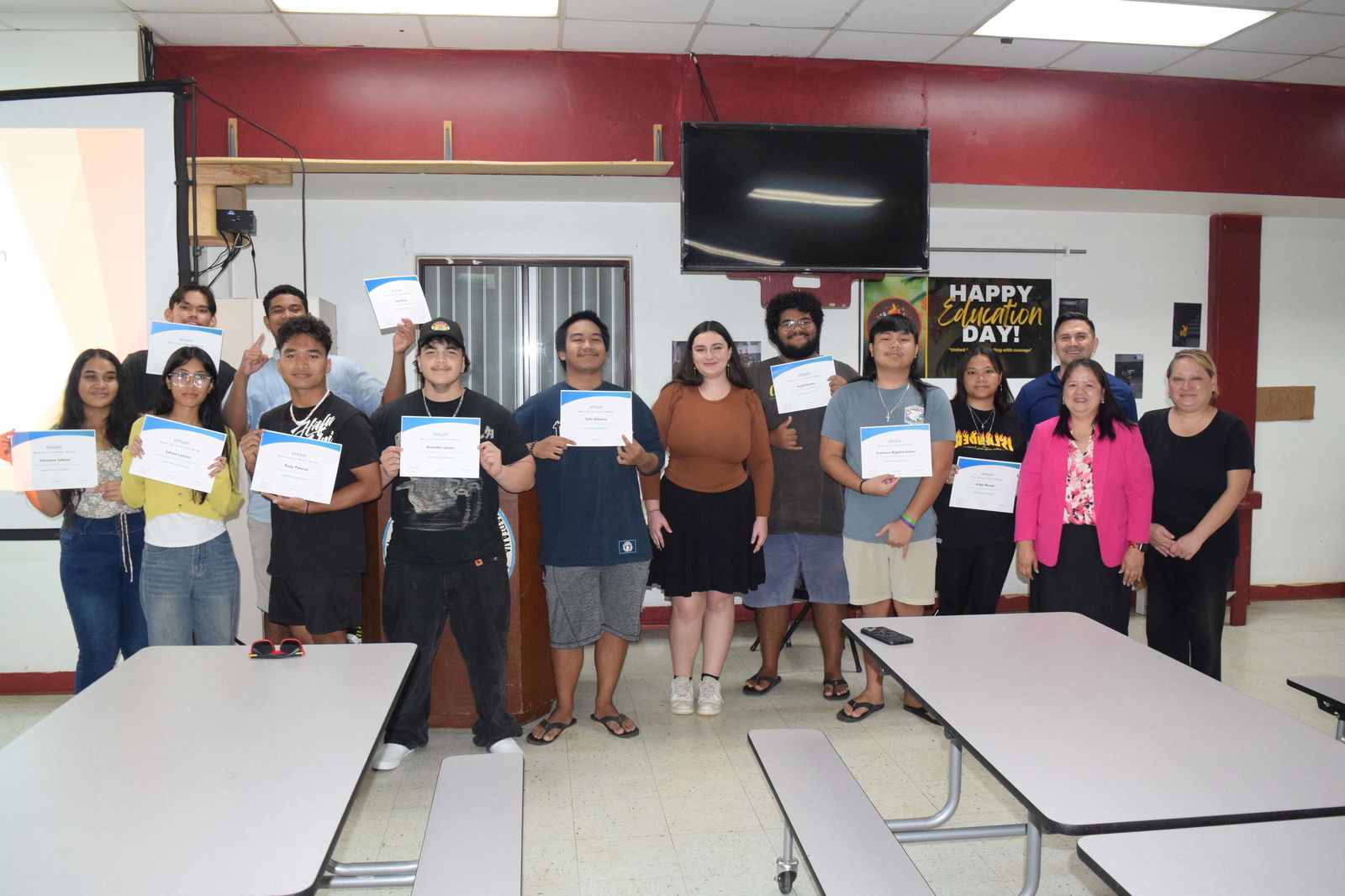 The Kagman High School students who completed the Intuit Personal Finance certification course pose for a photo with Public School System Senior Director for Curriculum and Instructional Services Dr. Rizalina Liwag, second right, PSS Career and Technical Education Program Director Dr. Jessica B. Taylor, right, Island Training Solutions Chief Operating Officer Alex Hu, right back row, and ITS instructor Shea Hartig, center, after the awarding of certificates in the KHS cafeteria on Friday.Photos by Emmanuel T. Erediano