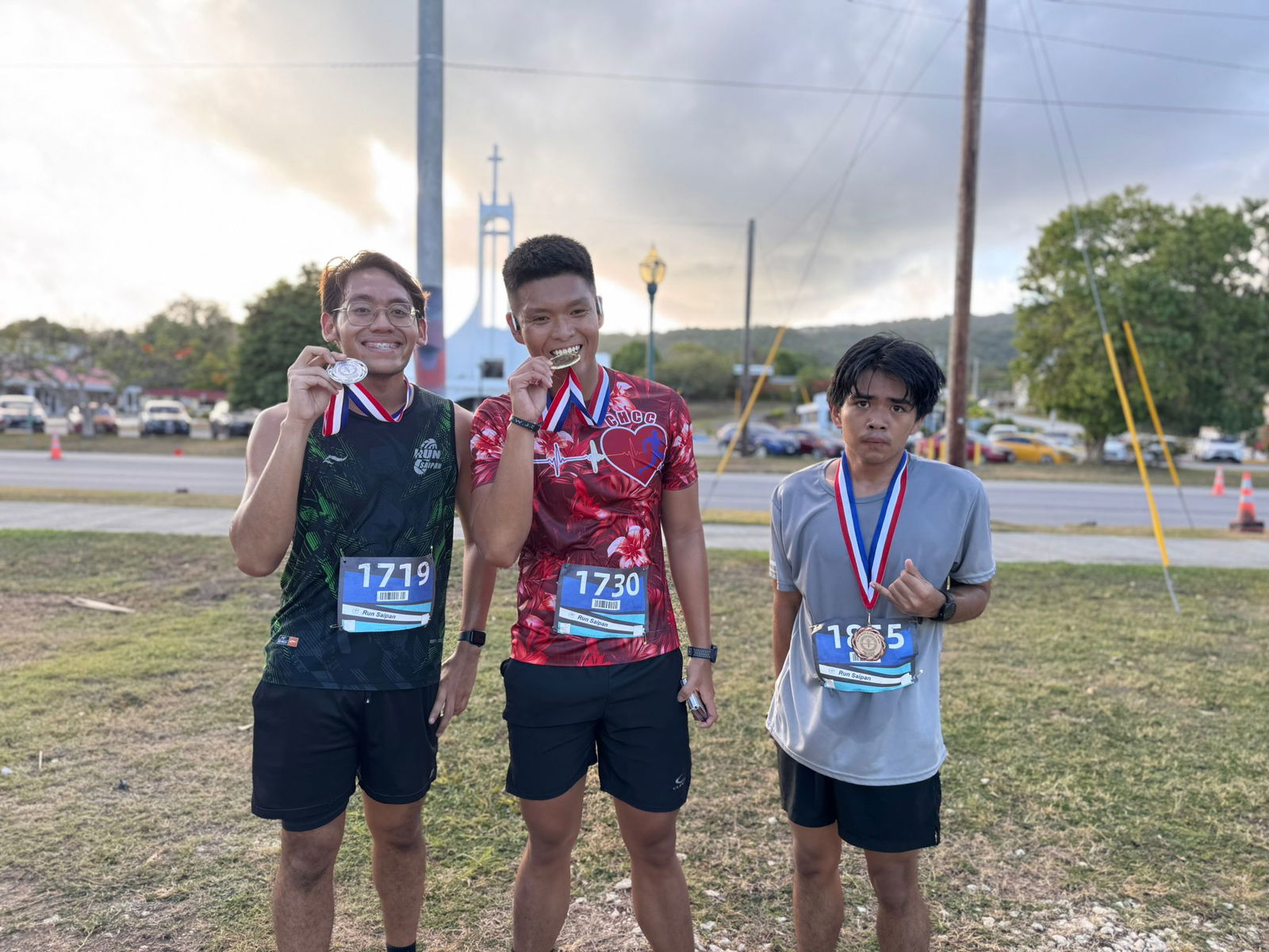 Philip Joseph Santos, Daryll De Luna, and Honofre Tangi pose as the top three finishers in the overall male division of the Mind, Body and Sole 5K at the Garapan Fishing Base on Friday.