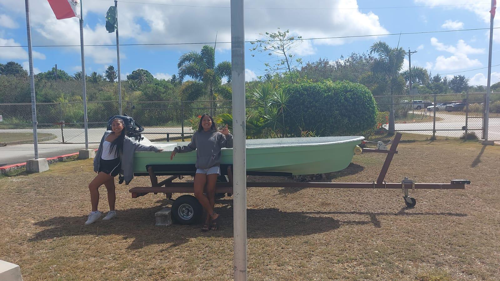 A picture of the boat with two of SIS’ Class of 2025 seniors.