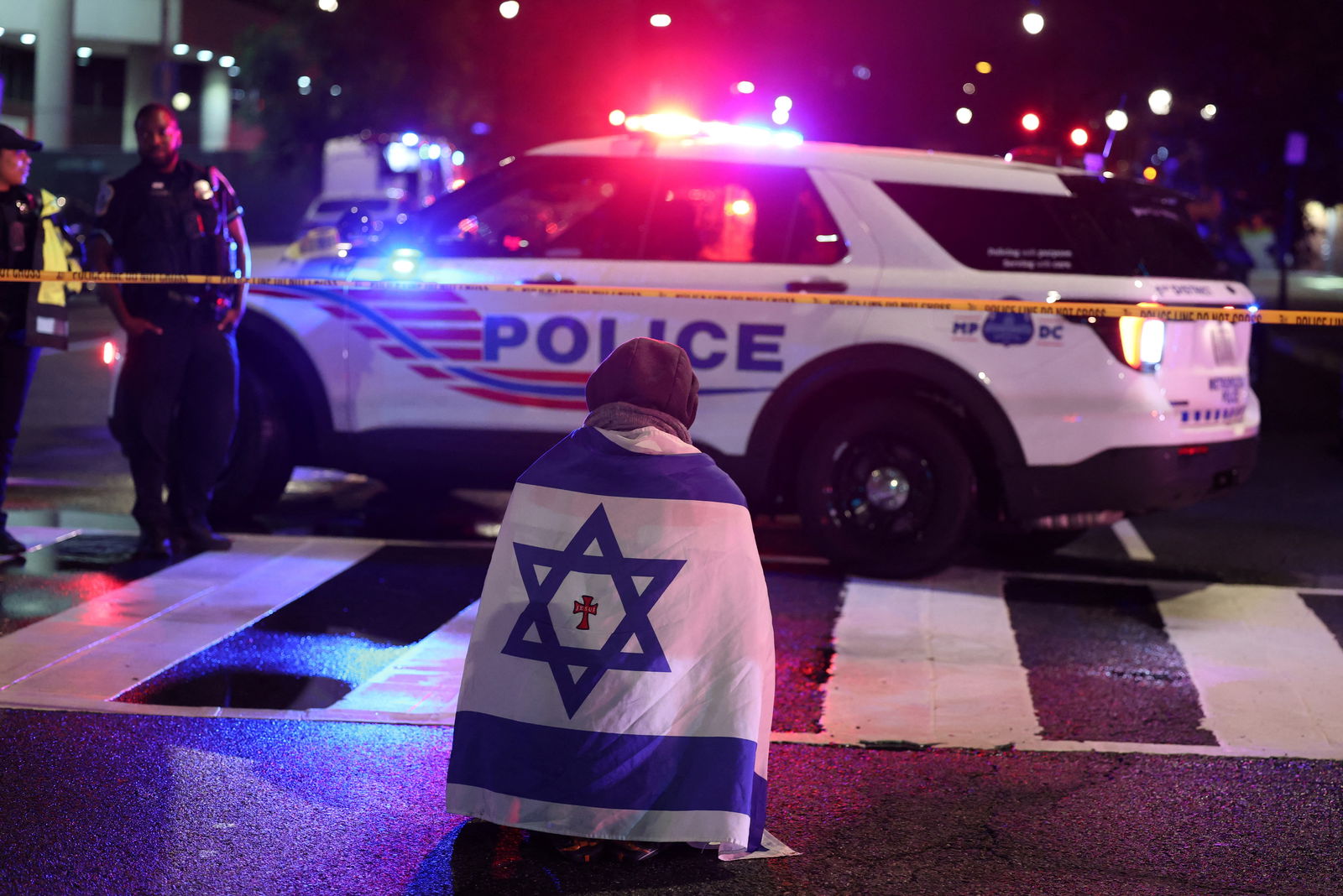 Emergency personnel work at the site where two Israeli embassy staff members were shot dead near the Capital Jewish Museum in Washington, D.C., May 21, 2025.REUTERS