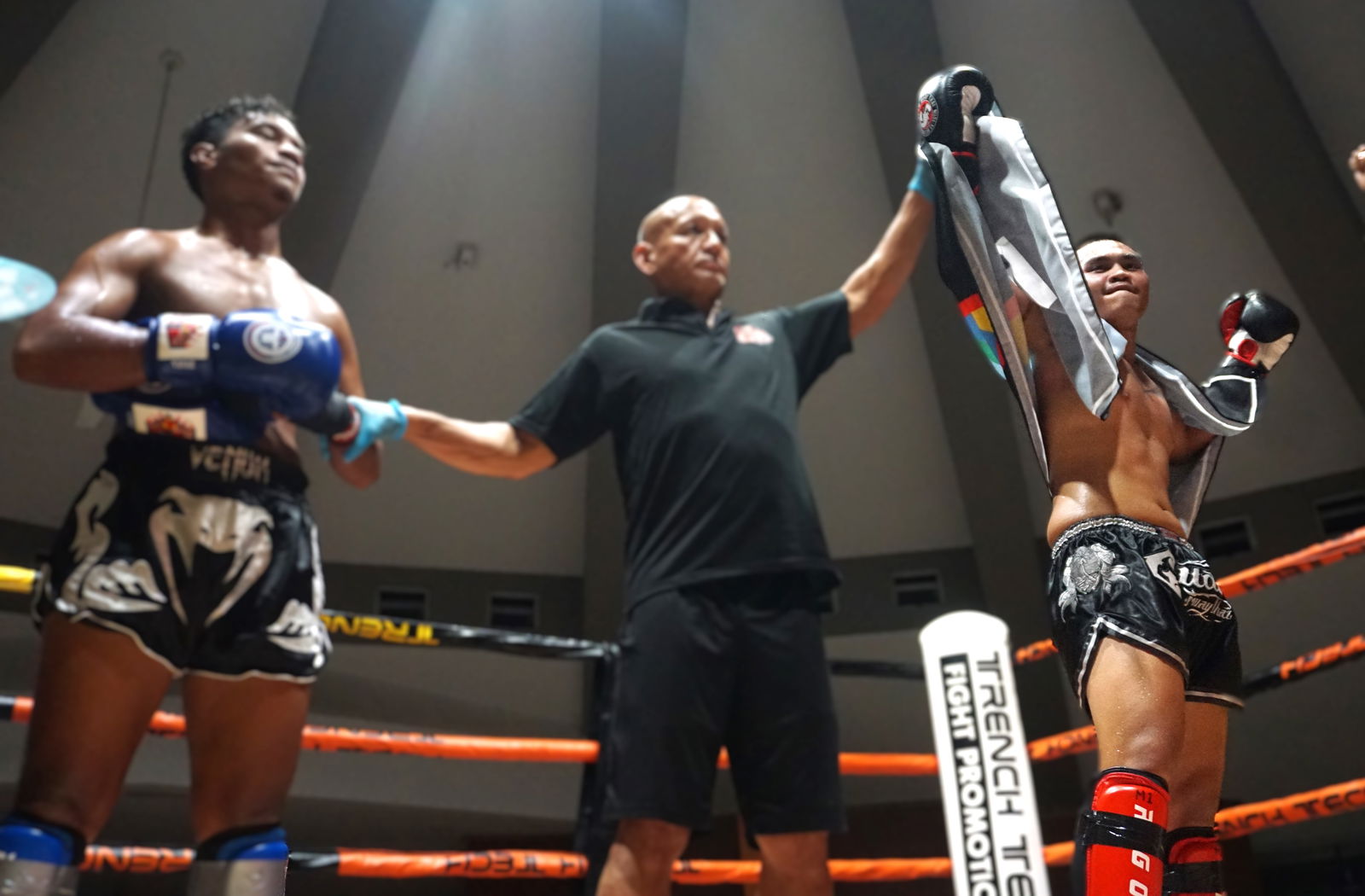 Harry Wells, right, has his hand raised as the winner of the main event against Teipo Asep at Ring of Fire 3, held at the Garapan Round House on Saturday night.Photo by James F. Sablan Jr.