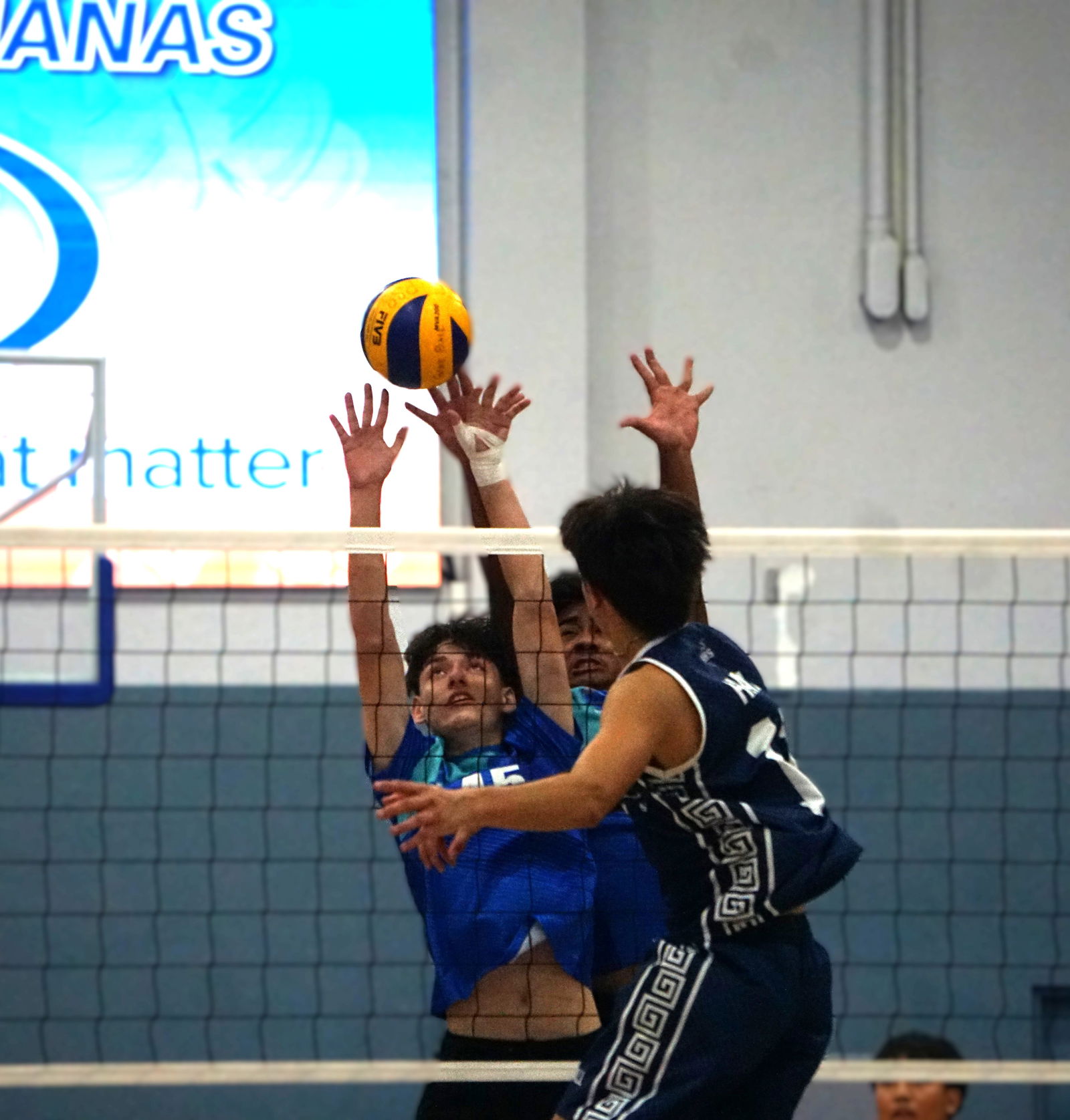MHS’ Jasper Hall unleashes a contested spike.