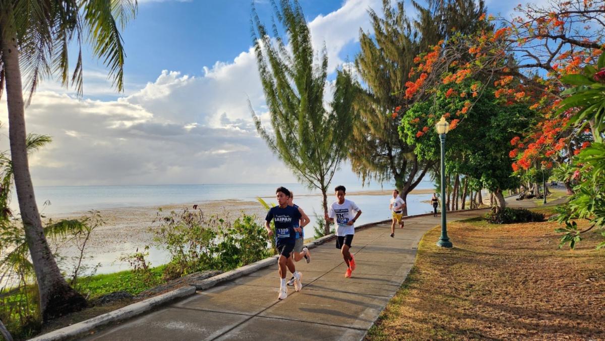 Nash Santos, front, sets the pace for a 1st place finish in the Marianas Tourism Month 5K Sunset Run on May 19, 2025, starting at Garapan Fishing Base.