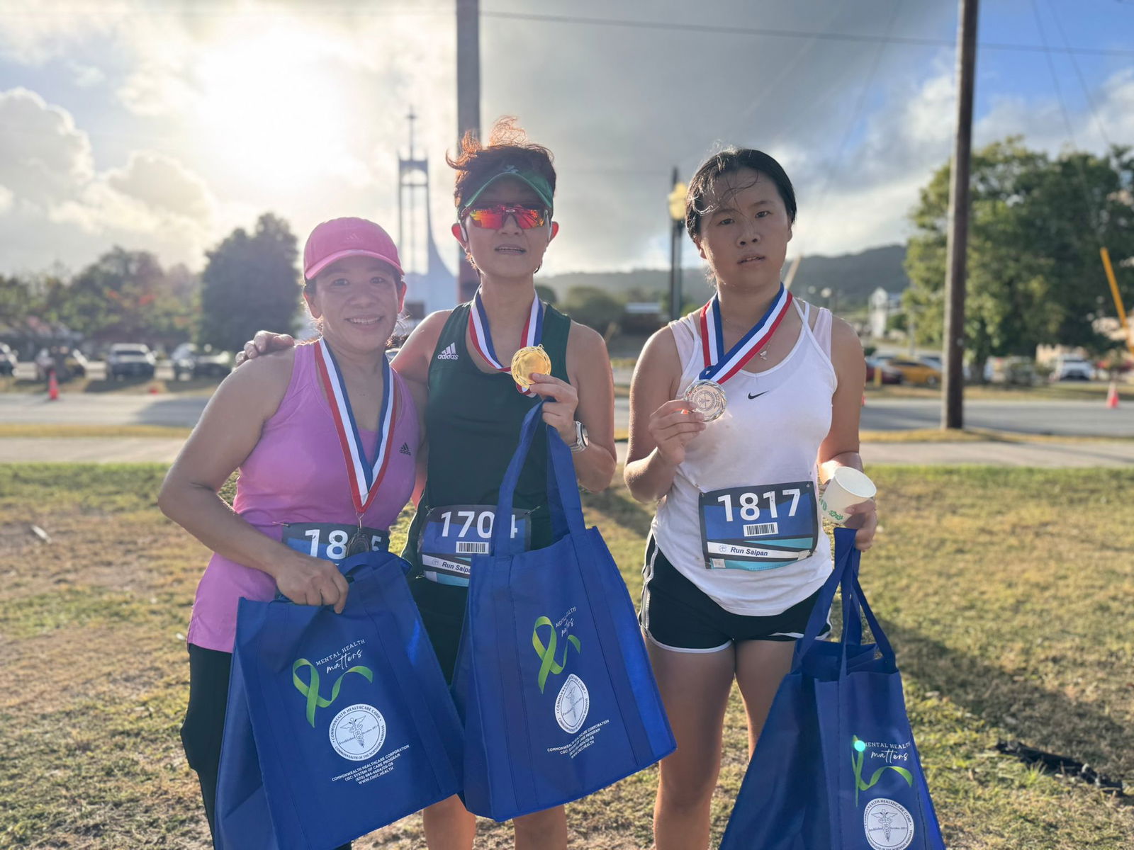 Rosemarie Chisato, An Bang, and Yuxi Zhang are the top three finishers in the overall female division of the Mind, Body and Sole 5K at the Garapan Fishing Base on Friday.