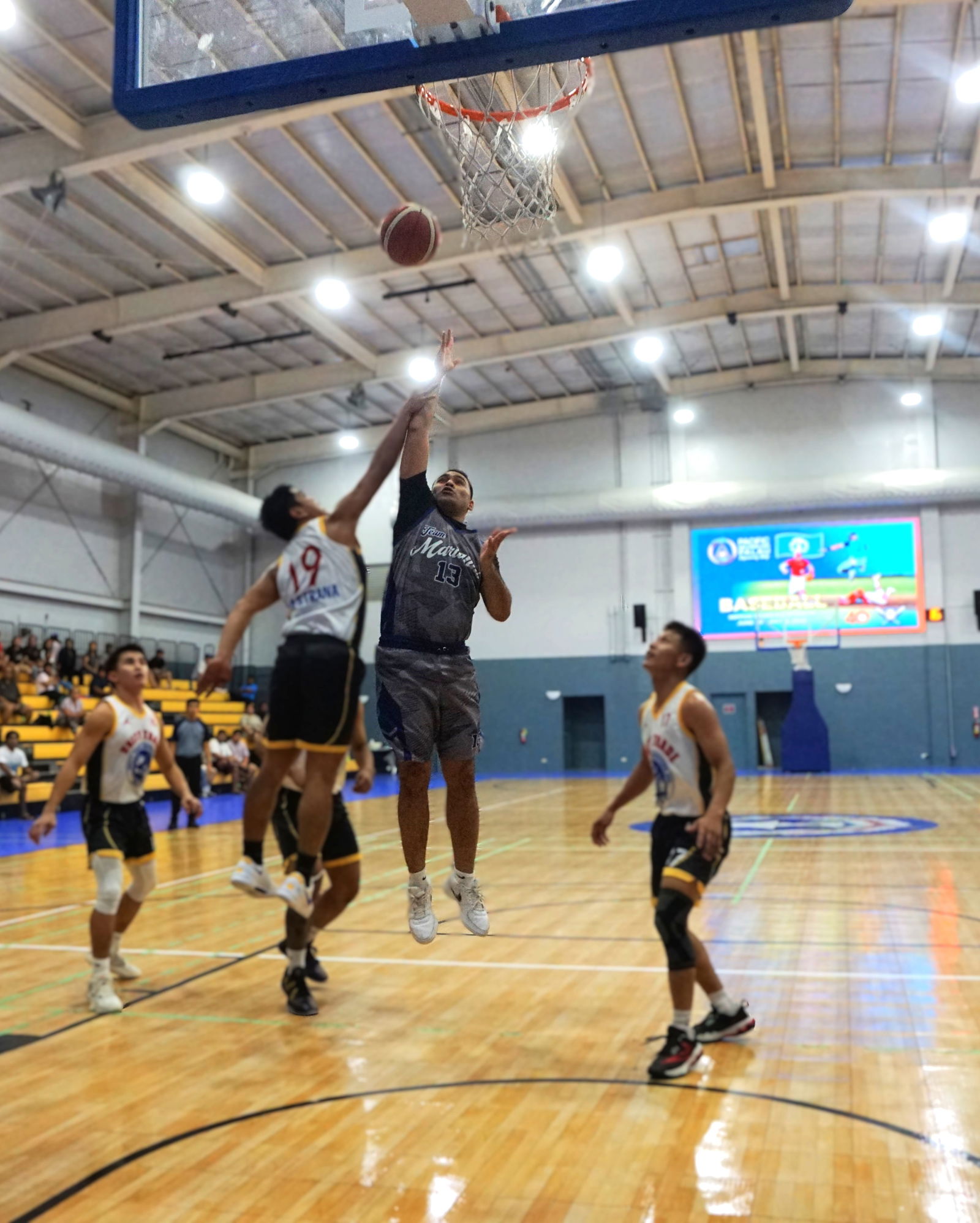Marianas’ Marvin Rabauliman gets fouled as he extends for the floater during the Michelob Ultra Cup championship game against Unity Trade at the Ada gym on Wednesday.Photo by James F. Sablan Jr.