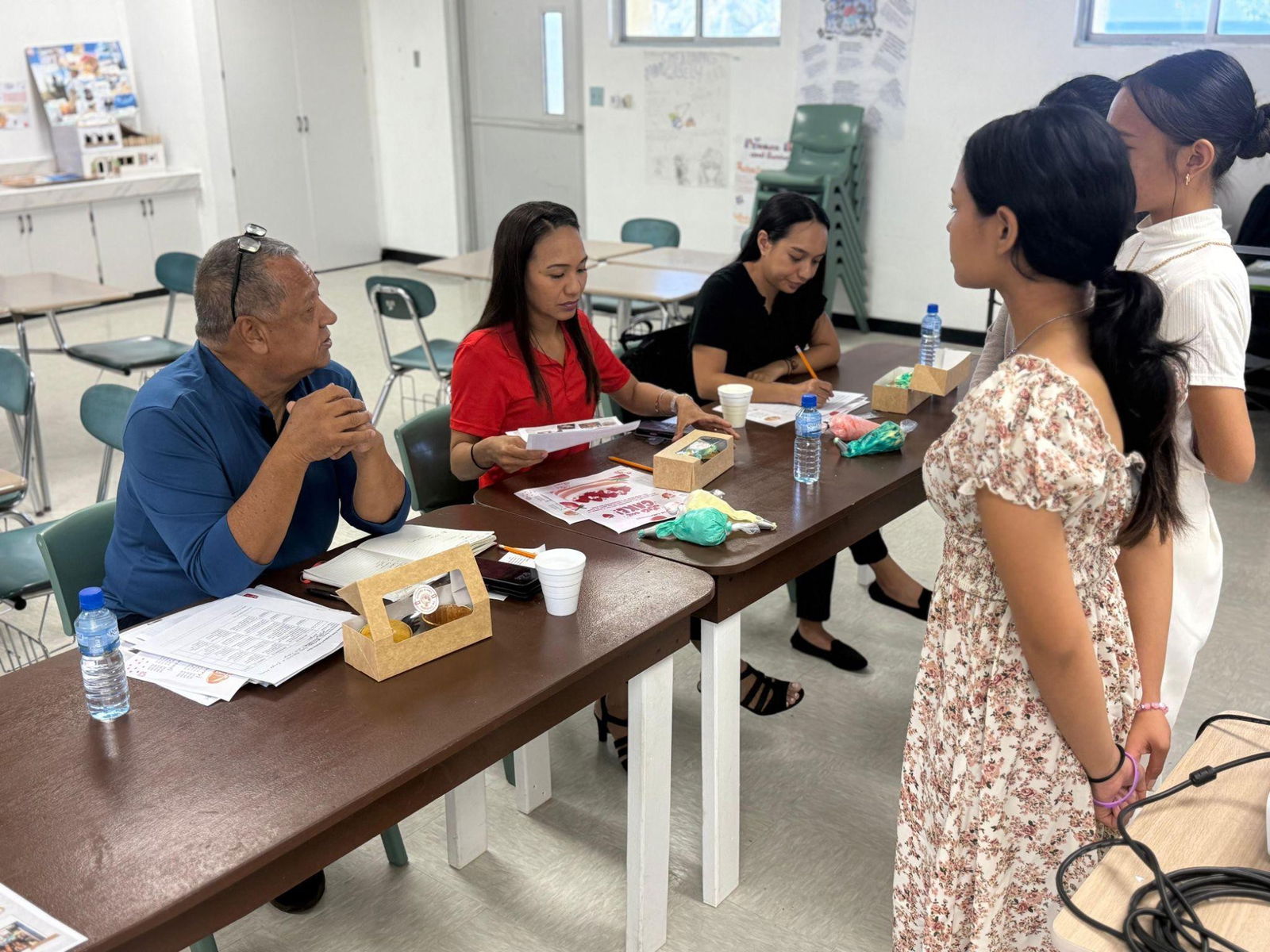Business community members Juan “Pan” Guerrero, Diana B. Hocog, and Dana Calvo comprise as the panelists for the Shark Tank competition, reviewing and interviewing the students' business proposals.