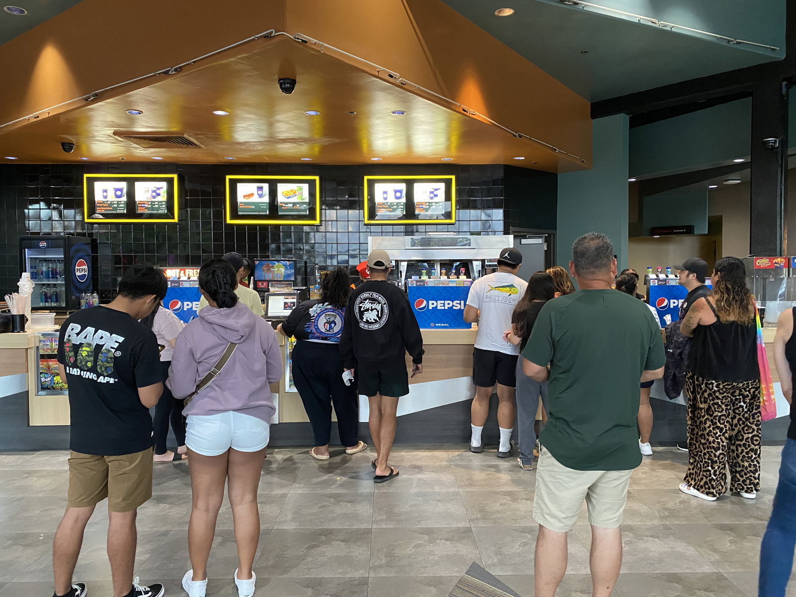 Moviegoers purchase popcorn and drinks at the concession stand on the final day of Hollywood Theaters, Wednesday.