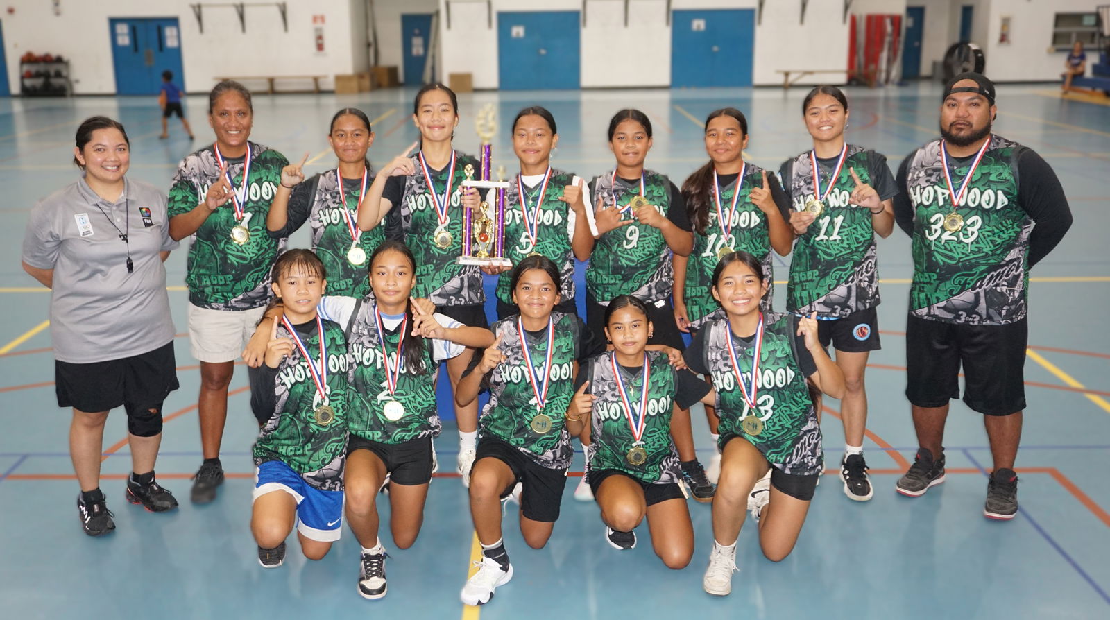 Hopwood Middle School players pose with the girls middle school division championship trophy of the PSS-IT&E Interscholastic Basketball League SY24-25 at the MHS gym.Photo by James F. Sablan Jr.