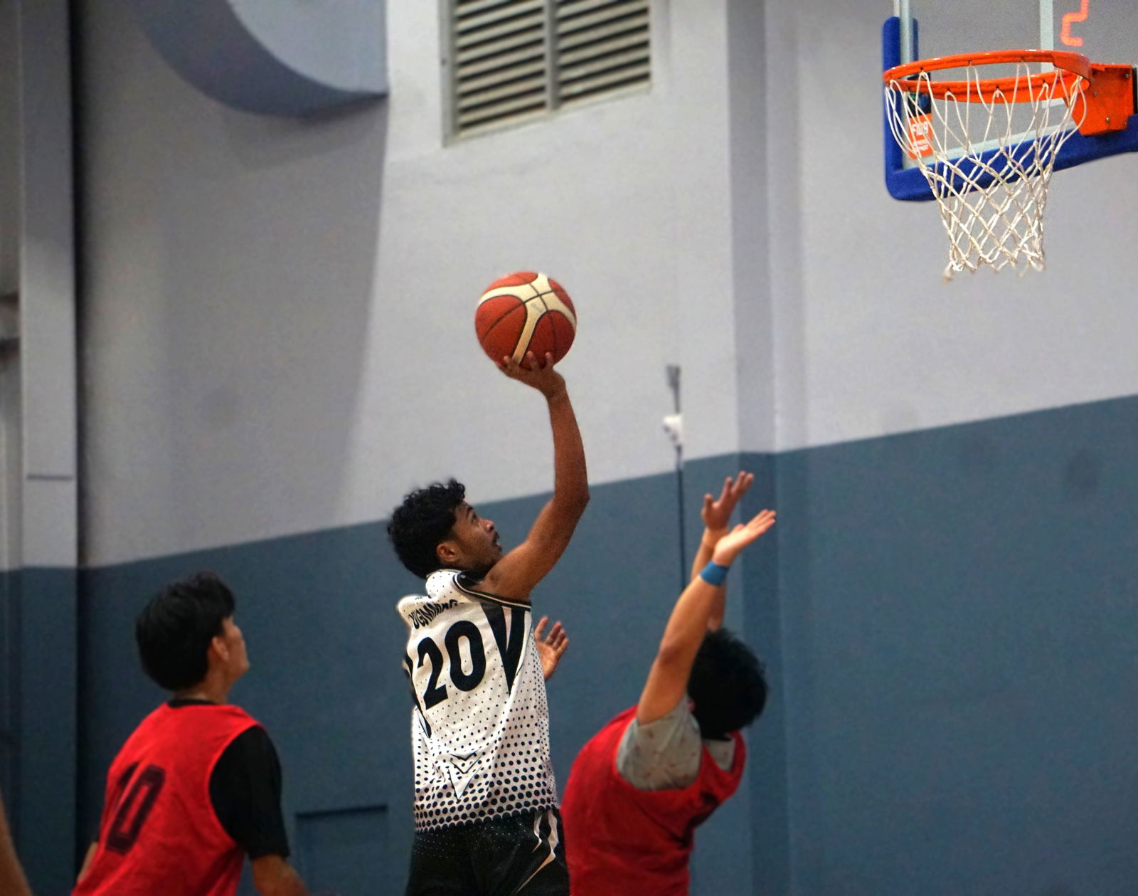 Eastside Cuts’ Jeffrey Yugummang extends for the contested floater against Akarri 2 during a Michelob Ultra Cup 2025 playoff game at the Ada gym on Wednesday.Photo by James F. Sablan Jr.