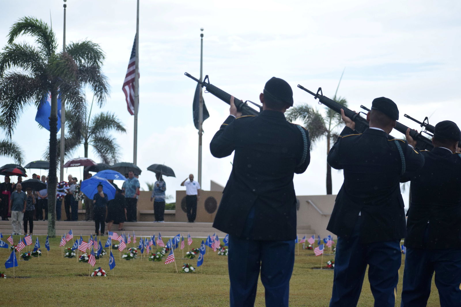 Members of Echo Company, 100th Battalion, 442nd Infantry Regiment, and the 302nd Quartermaster Company, U.S. Army Reserve, fire a 21-gun salute.