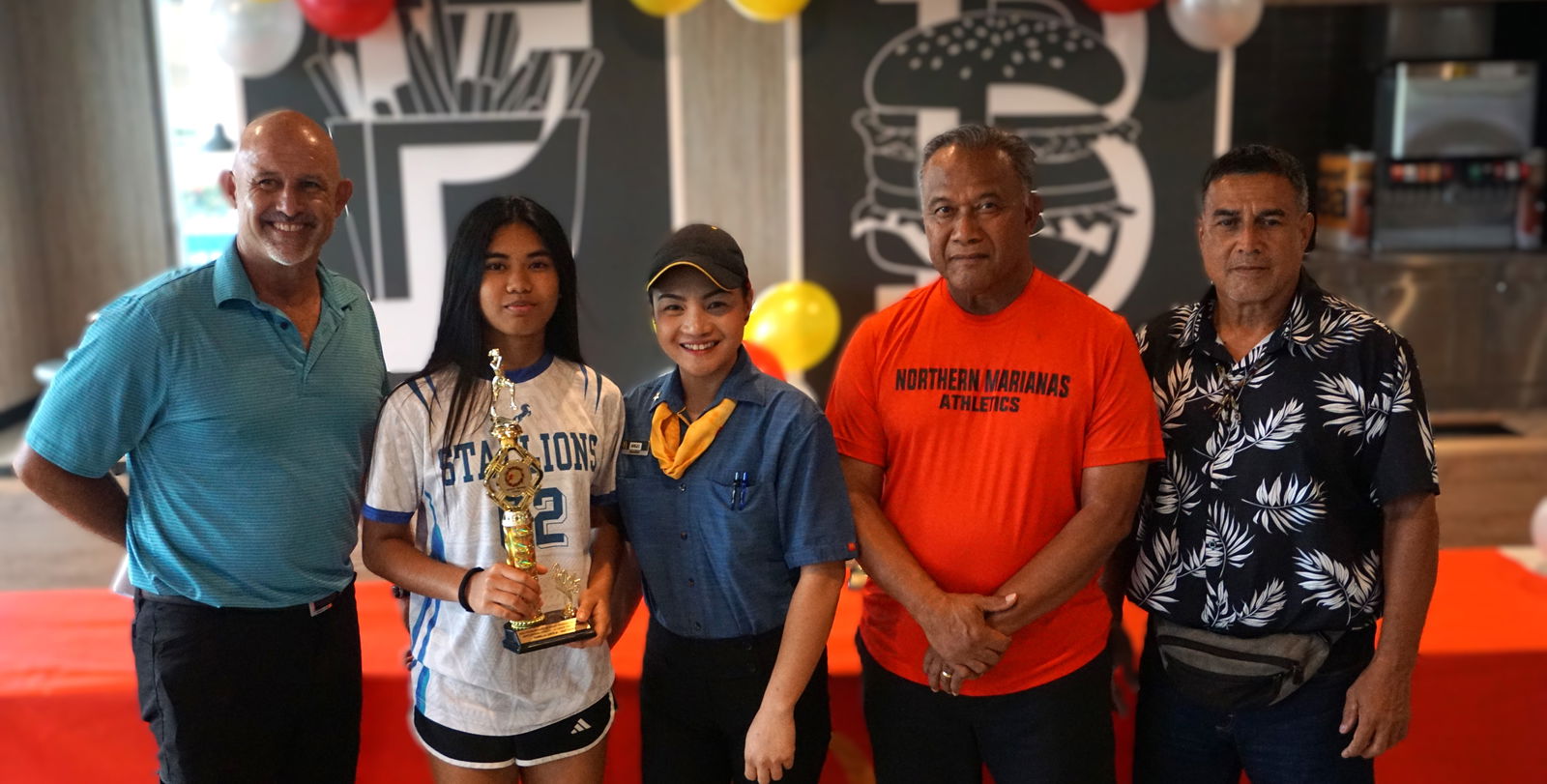 14U girls MVP, Tinian Jr./Sr, High School's Ysabella Lanteja, poses for a photo with PSS Athletics Program Director Nick Gross, McDonald's Middle Road acting general manager Angelica Darlucio, Northern Marianas Athletics President Ray Tebuteb, and longtime national coach Rep. Elias Rangamar.Photo by James F. Sablan Jr.