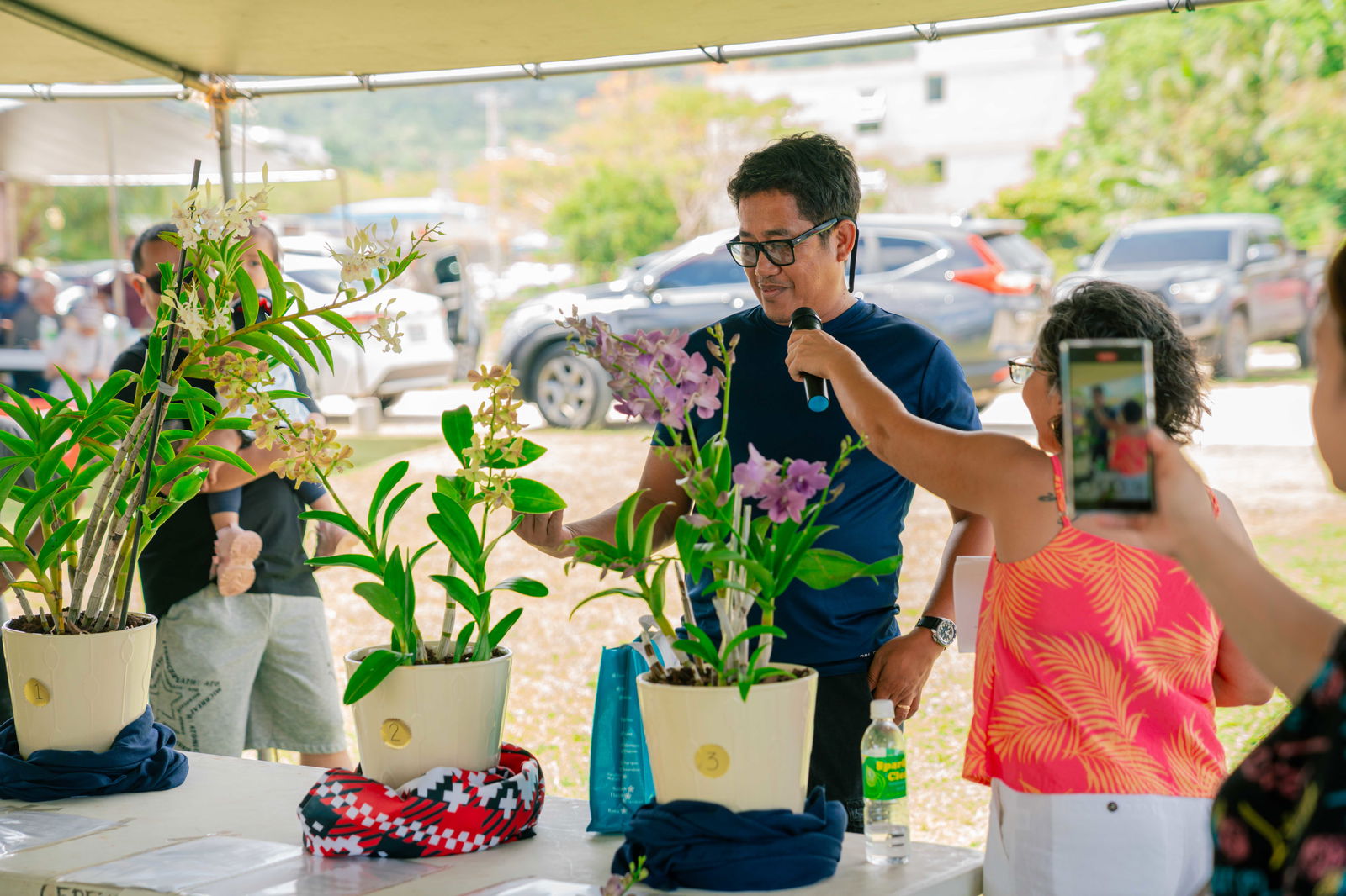 Rep. Marissa Flores interviews Dennis Calunsag, 2nd Place winner of the Dendrobium category.