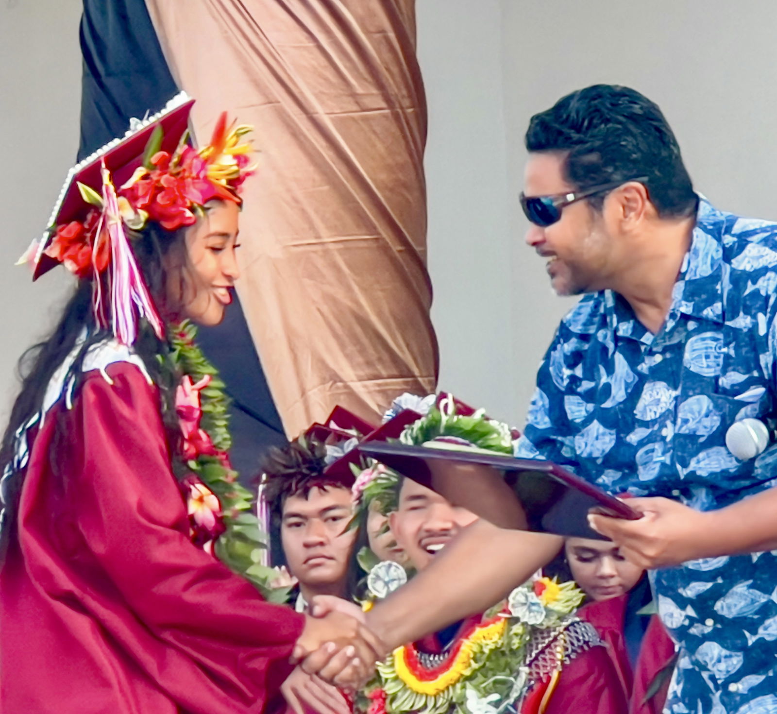 Valedictorian Jayda Isis Lizama Norita is congratulated by BOE Chairman Aschumar Kodep Ogumoro-Uludong.