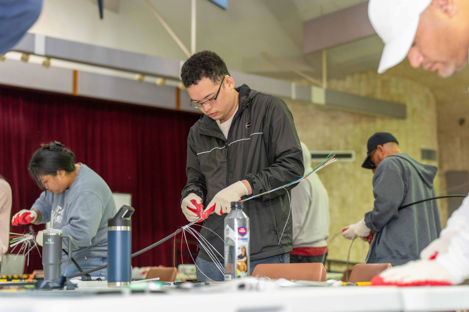A Saipan participant of the Governor’s Broadband Bootcamp prepares fiber optic cable as part of his final exam.NMC photo