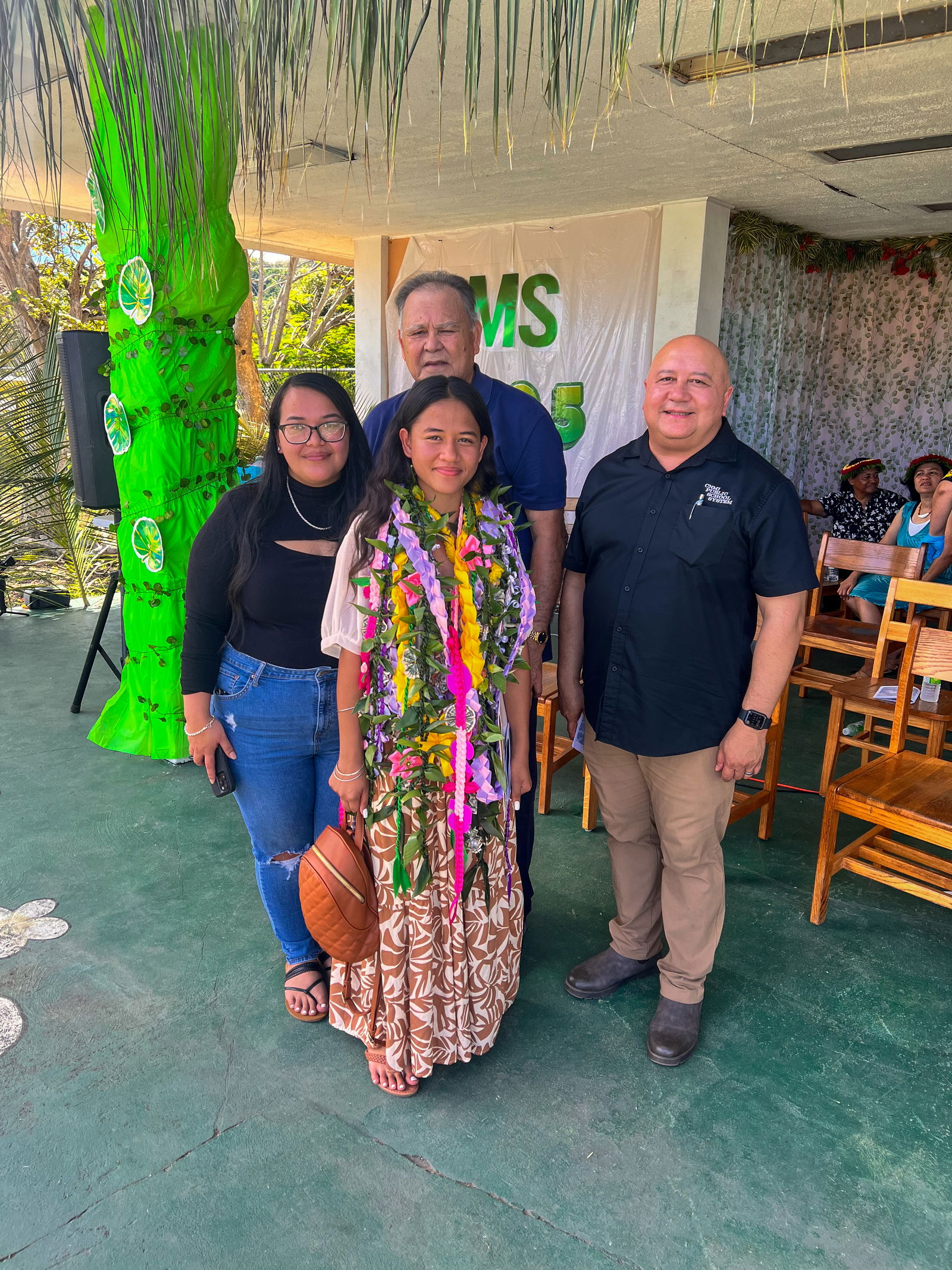 Commissioner of Education Dr. Lawrence F. Camacho with promoted student Callie Abraham and her family.