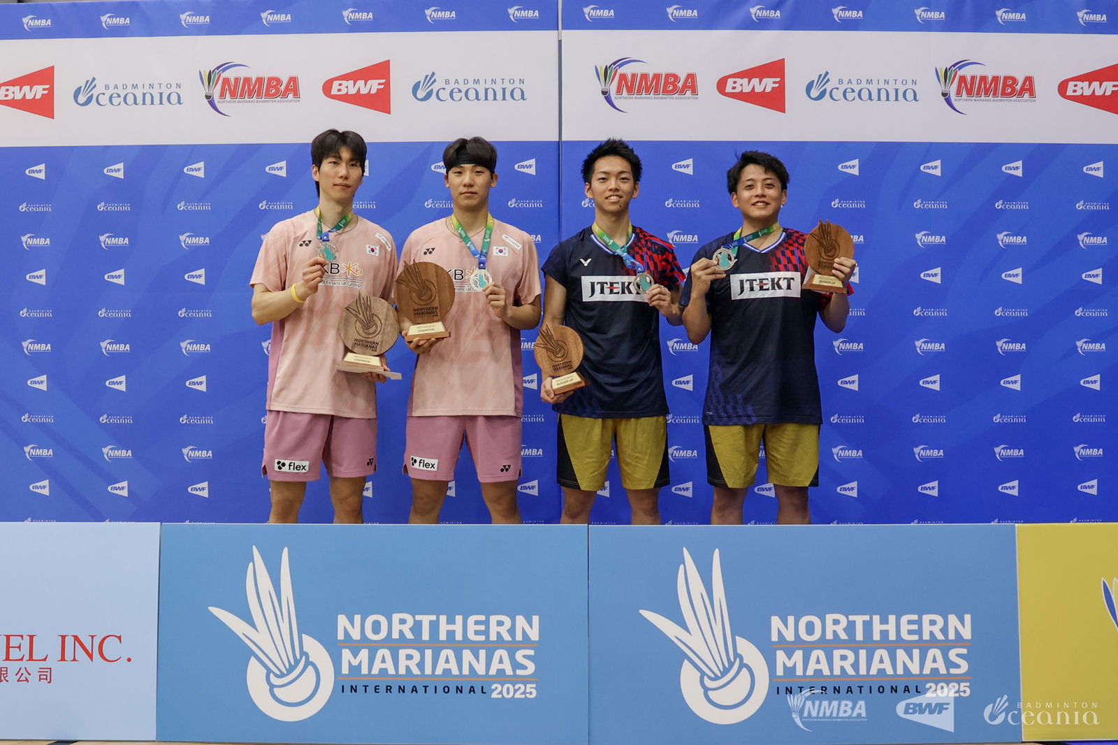 Kim Jae Hyeon and Lee Sang Won, left, pose as the men's doubles champions alongside Akira Koga and Naoya Kawashima as the runners-up during the awards ceremony of the Northern Marianas International 2025 held at the Gilbert C. Ada gym on Saturday.Northern Marianas Badminton Association photo