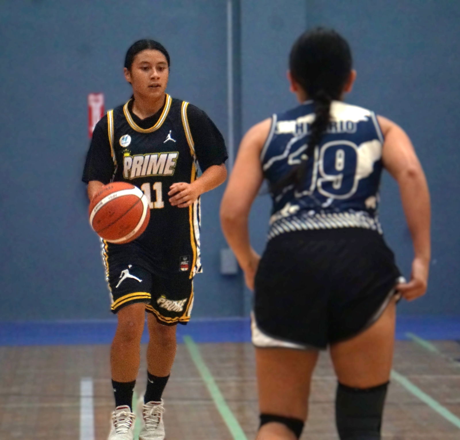 Prime’s Rosie Saralu looks for a teammate as she brings the ball downcourt during a women’s open division game in the 2025 Allied Pacific Environmental Consulting Basketball League at the Ada Gym.Photo by James F. Sablan Jr.