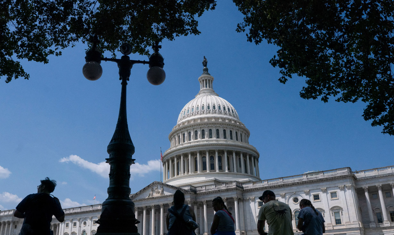 Visitors to the U.S. Capitol rest in the shade in Washington, D.C., June 25, 2025.REUTERS
