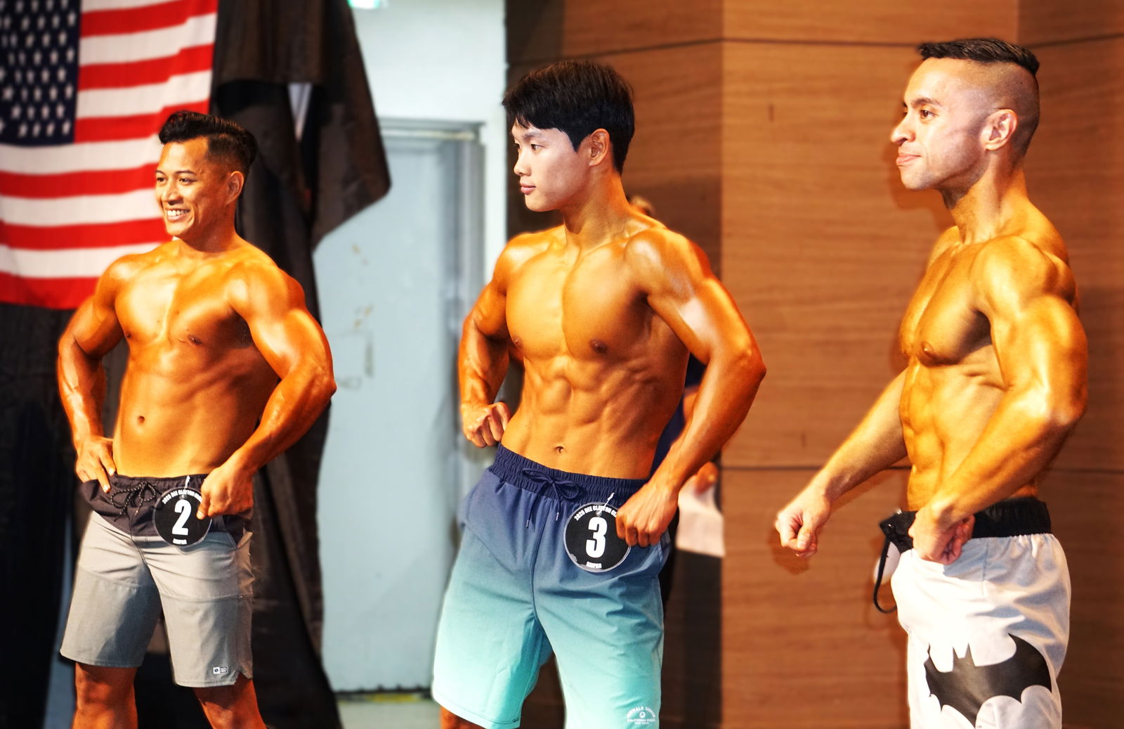 Reymark Castro, Evan Choi, and Shawn Fleming pose for the judges during the men’s physique short division competition.Photo by James F. Sablan Jr.