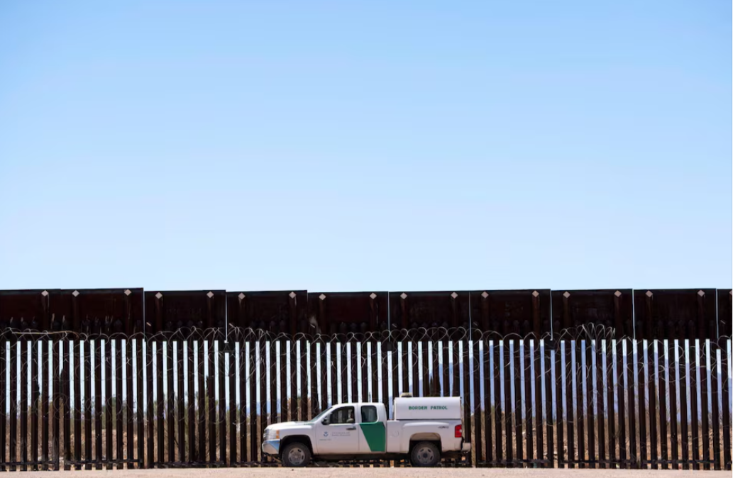 A U.S. Border Patrol agent sits in a vehicle while surveilling a section of the U.S.-Mexico border fence in Douglas, Arizona, April 20, 2025.REUTERS