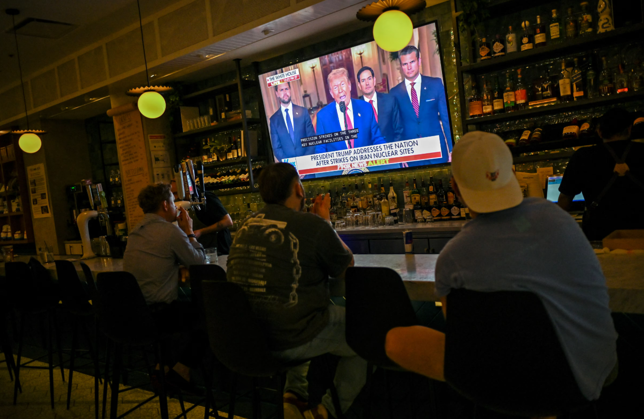 Patrons of the Chapel Street Cafe watch as President Donald Trump delivers an address to the nation following U.S. strikes on Iran's nuclear facilities, in Chicago, Illinois, June 21, 2025.REUTERS