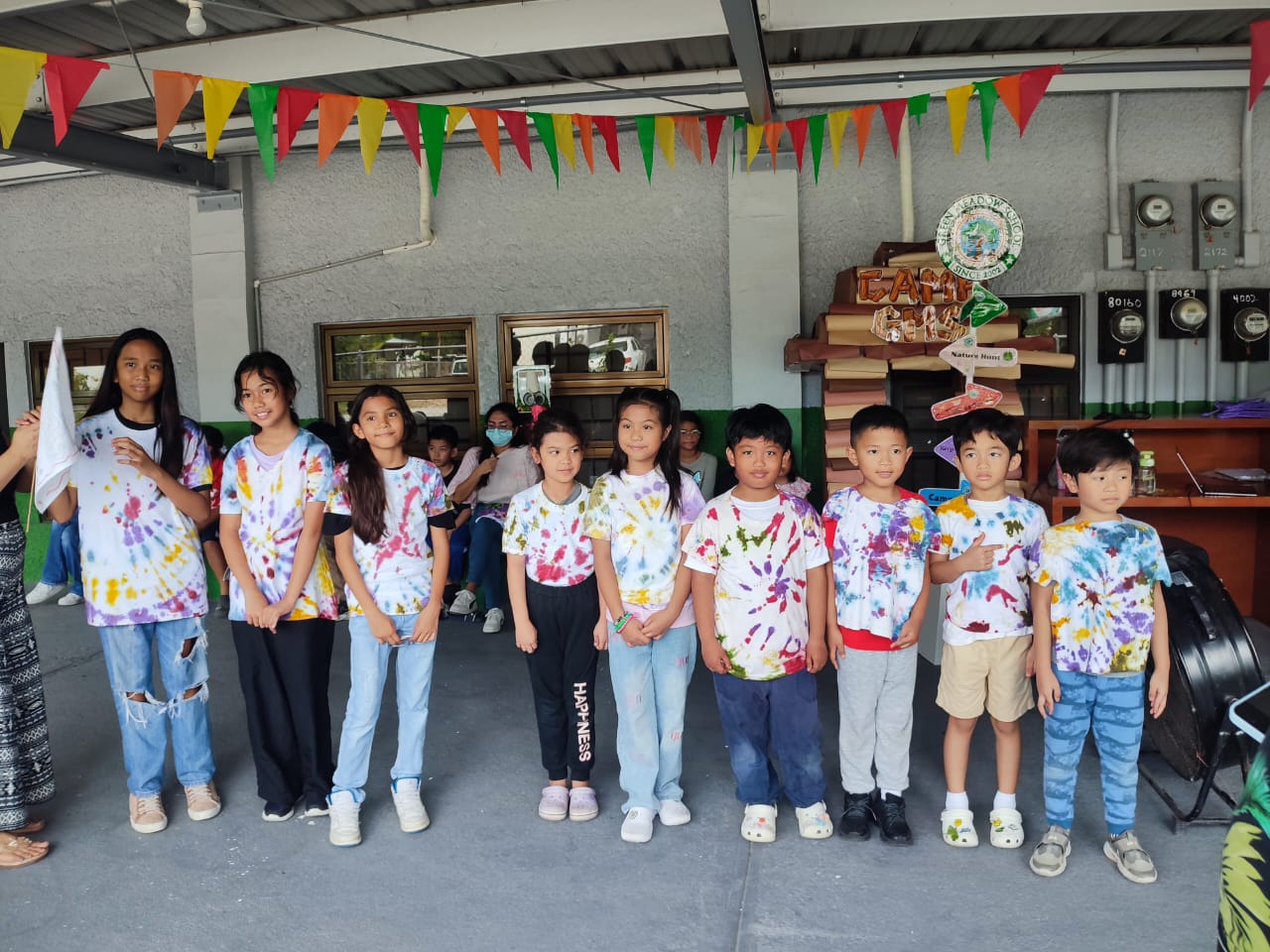 Art extravaganza: Campers enjoy a team-based T-shirt dyeing competition filled with color and creativity.