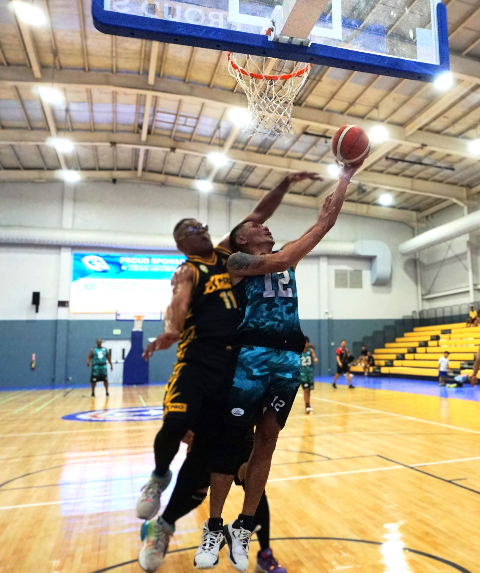 A+'s Joel Javier gets fouled as he goes up for the reverse layup.Photo by James F. Sablan Jr.