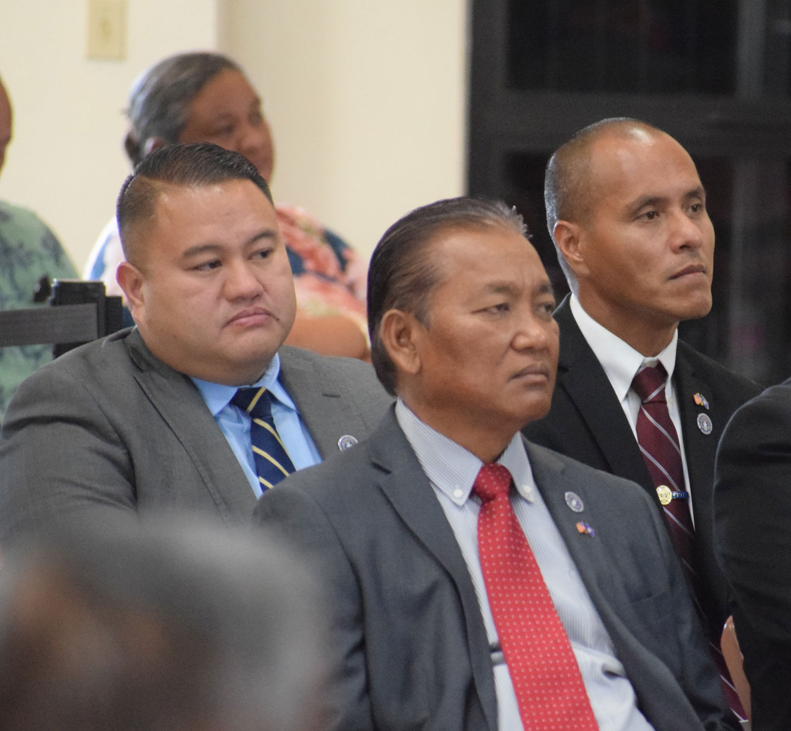 Sens. Manny Gregory Castro, Frank Q. Cruz and Ronnie Calvo listen to Gov. Arnold I. Palacios’ State of the Commonwealth Address at the multi-purpose center in Susupe on Thursday. Photo by Emmanuel T. Erediano