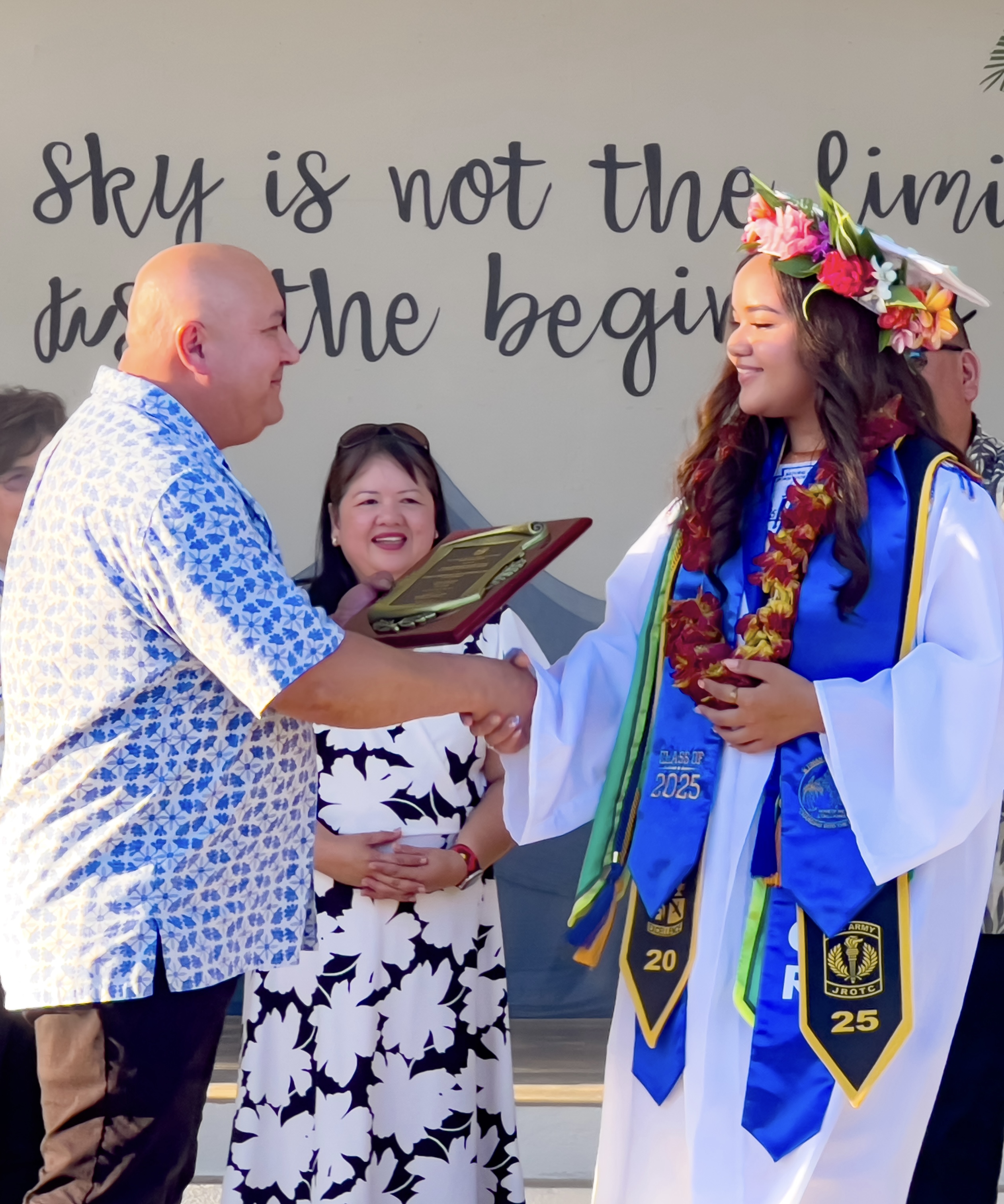 Commissioner of Education Dr. Lawrence F. Camacho presents the Commissioner of Education Academic Excellence Award to class salutatorian Ysabella Nikonia Rita Villagomez Palacios.