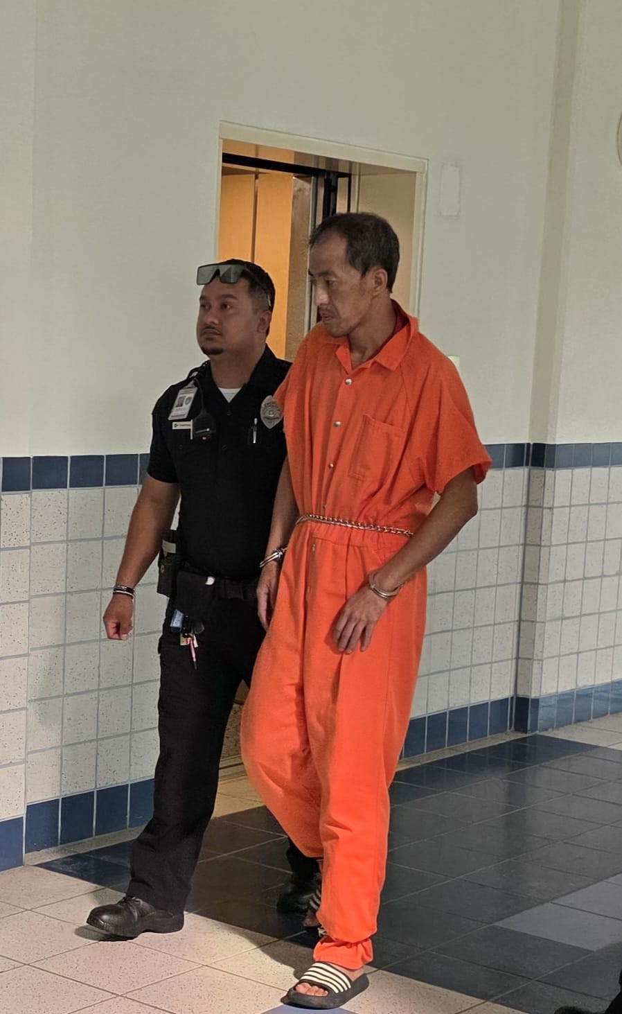 Guojing Chen is escorted by a Corrections officer to a bail hearing at the Guma’ Hustisia on Wednesday afternoon.Photo by Bryan Manabat