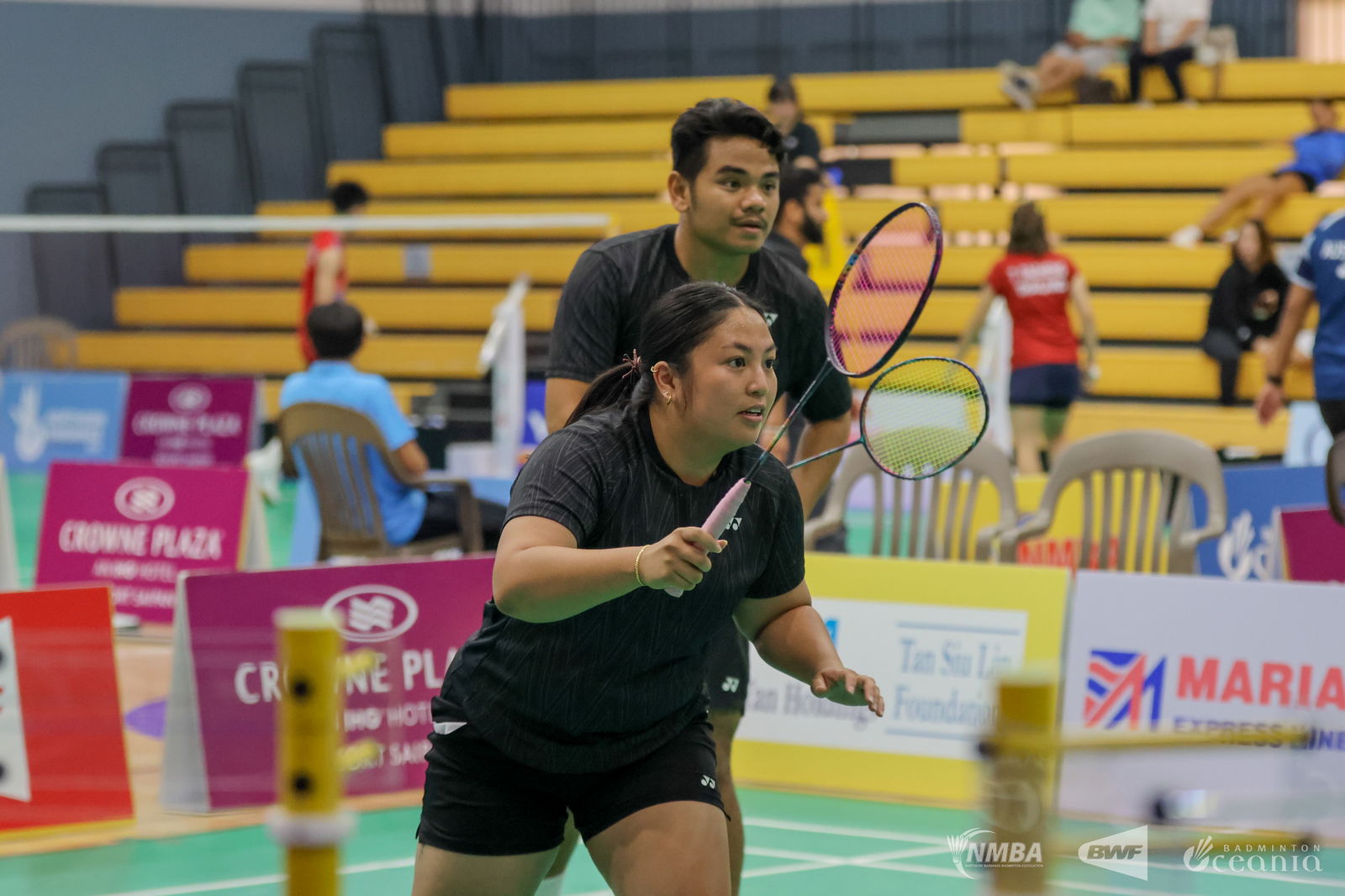 NMI’s Daniell Pablo and Janelle Pangilinan prepare to receive a serve during a mixed doubles match on Day 2 of the 2025 Northern Marianas International at the Ada Gym on Wednesday.Northern Marianas Badminton Association photo