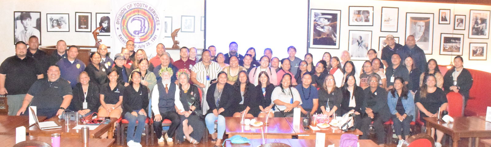 The participants and guest speakers of the Division of Youth Services' inaugural Addressing Adverse Childhood Experiences training pose for a group photo during a break at Aqua Resort Club's Kevin Restaurant on Friday.