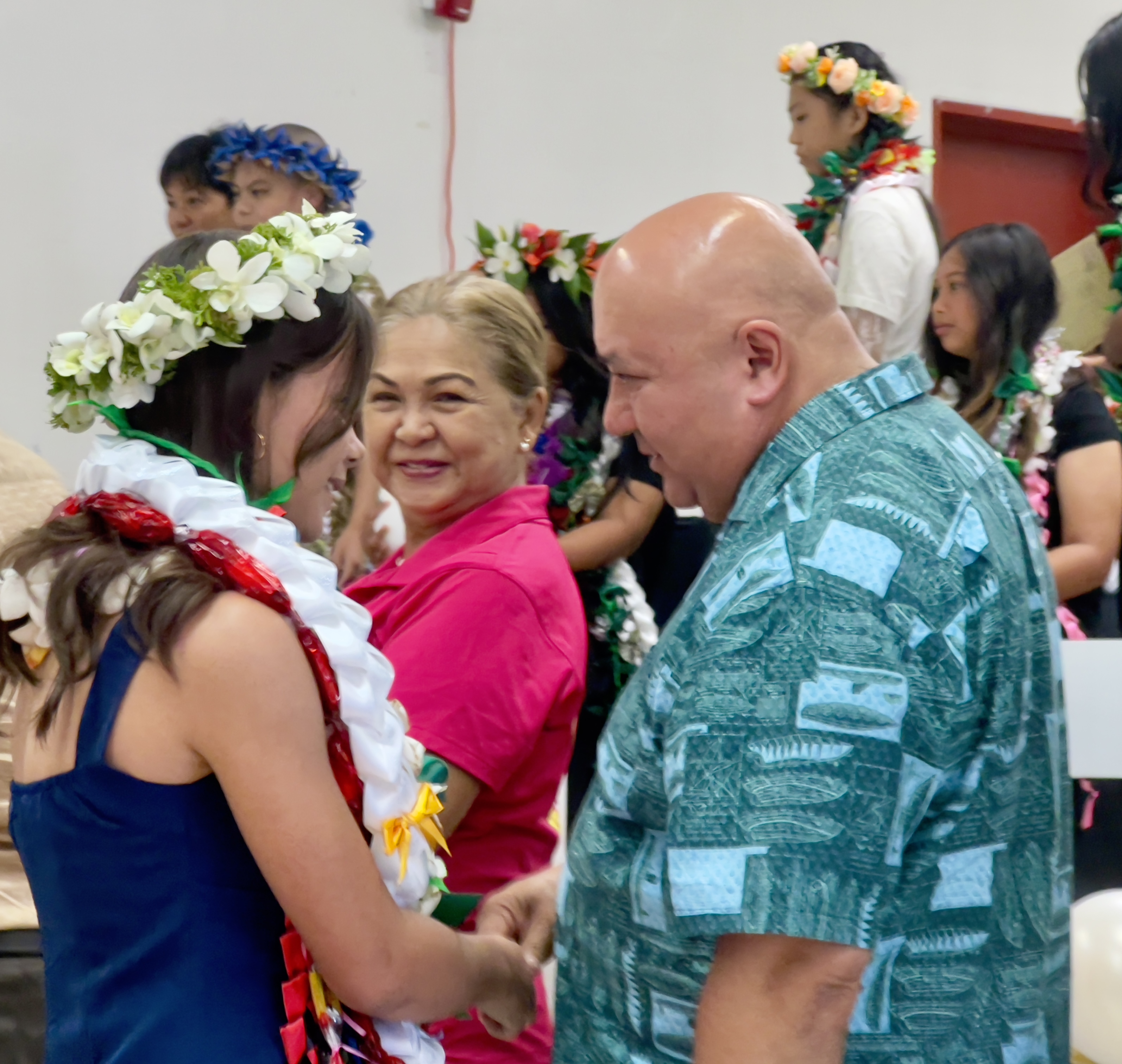 Commissioner of Education Dr. Lawrence F. Camacho congratulates salutatorian Piper Rose Christian as Special Assistant for Women’s Affairs Barbara Sablan looks on.