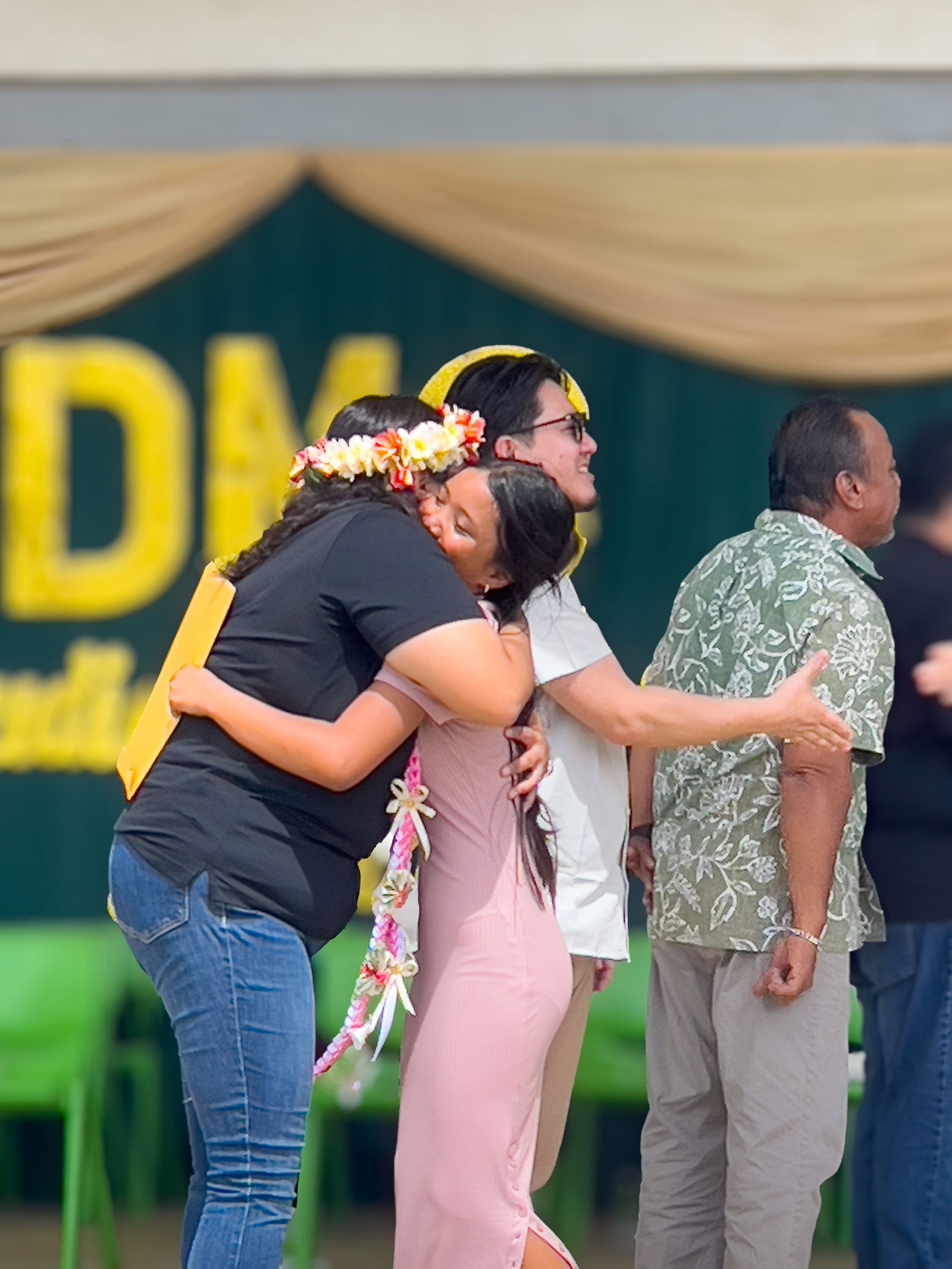 A promoted student receives a hug from her homeroom teacher.