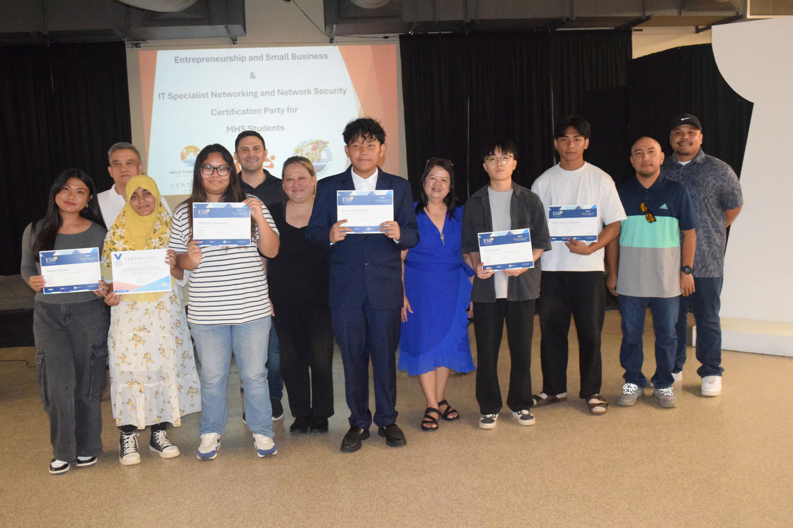 The six Marianas High School students who completed the Entrepreneurship and Small Business certification course pose for a photo with Public School System Senior Director for Curriculum and Instructional Services Dr. Rizalina Liwag, PSS Career and Technical Education Program Manager Jessica Taylor, MHS Vice Principal Preston Basa, Island Training Solutions Chief Operating Officer Alex Hu and ITS instructor Herman Kintol in the MHS cafeteria on Friday.Photo by Emmanuel T. Erediano