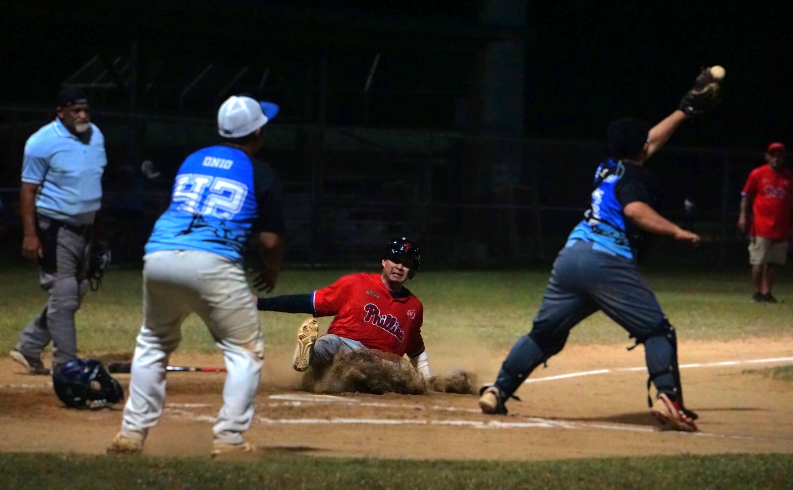 The Phillies' TJ Sablan slides his way home for an earned run against the Blue Shark during a 2025 Saipan Baseball League game at the Francisco "Tan Ko" Palacios Baseball Field on Thursday.Photo by James F. Sablan Jr.