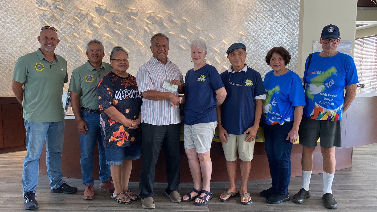 Ray Tebuteb accepts a check on behalf of the Northern Marianas Sports Association.