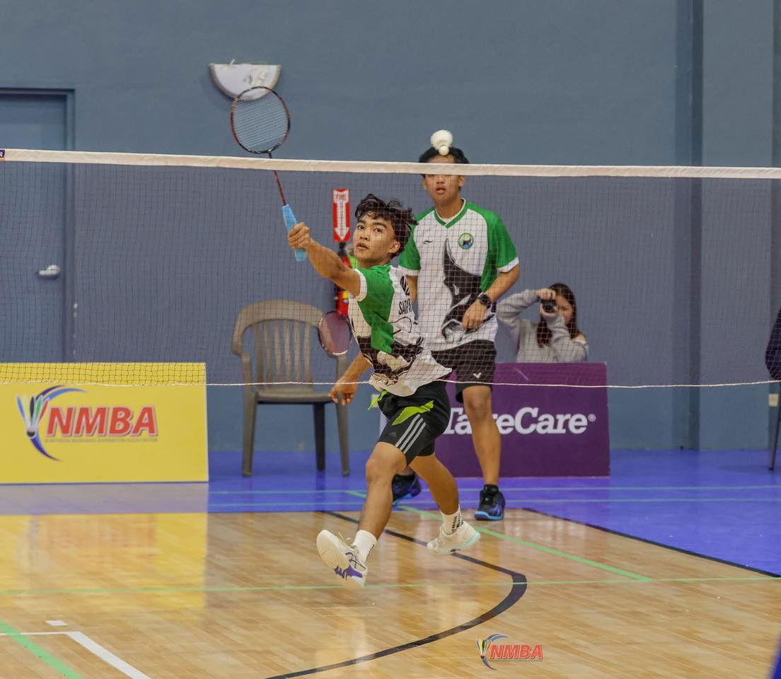 Nolan Nate goes for a return during his and Jude Mallari’s men’s doubles game in the PSS-TakeCare Interscholastic Badminton League, High School Division. He will be among the NMI players competing in next week’s VICTOR Oceania Junior Championships 2025 at the Gilbert C. Ada Gymnasium.Contributed photo