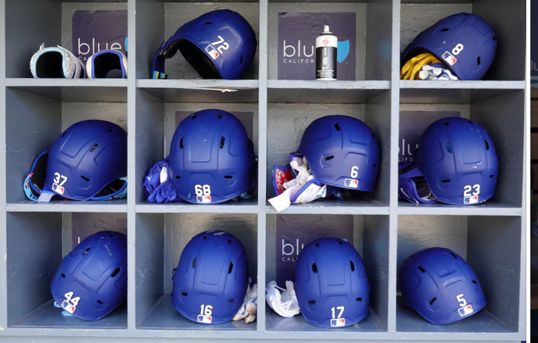 The batting helmets of Los Angeles Dodgers hitting coach Robert Van Scoyoc (72), first baseman Enrique Hernandez (8), right fielder Teoscar Hernandez (37), catcher Dalton Rushing (68), center fielder Hyeseong Kim (6), third baseman Max Muncy (13), left fielder Andy Pages (44), catcher Will Smith (16), designated hitter Shohei Ohtani (17) and first baseman Freddie Freeman (5) in the dugout at Dodger Stadium in Los Angeles, California, June 18, 2025.Photo by Kirby Lee/Imagn Images