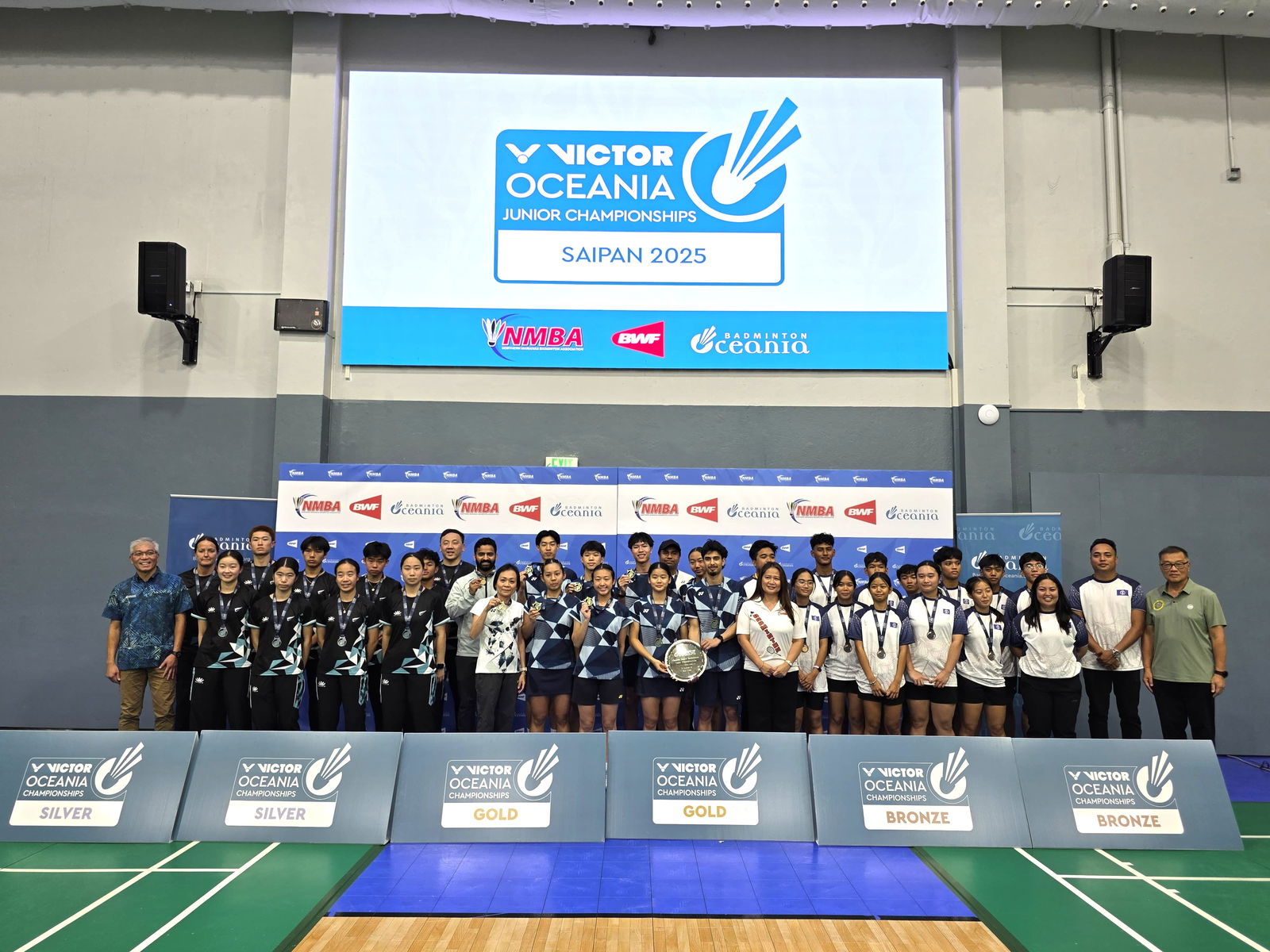 New Zealand, Australia, and NMI players pose together as the medalists of the VICTOR Oceania Junior Team Championships 2025 during the awards ceremony at the Ada gym on Tuesday.Photo by James F. Sablan Jr.