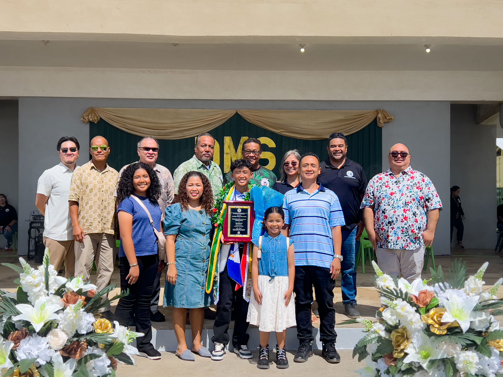 Class salutatorian and Commissioner of Education Award recipient Yuxi Lu poses for a photo with his family along with Public School System officials and Dandan Middle School administrators.